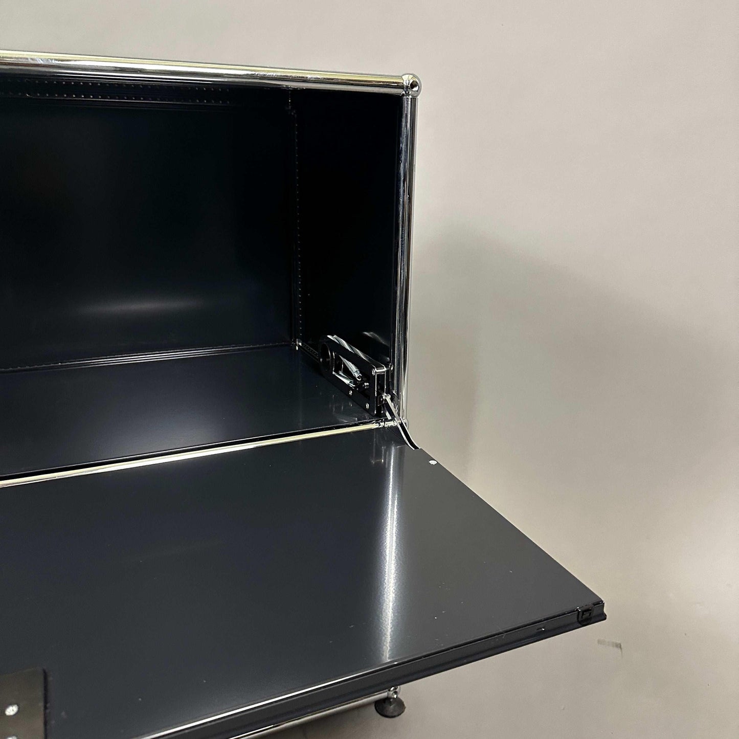 USM Haller Sideboard 1x2 in graphite black with two lockable drop-down doors and chrome frame
