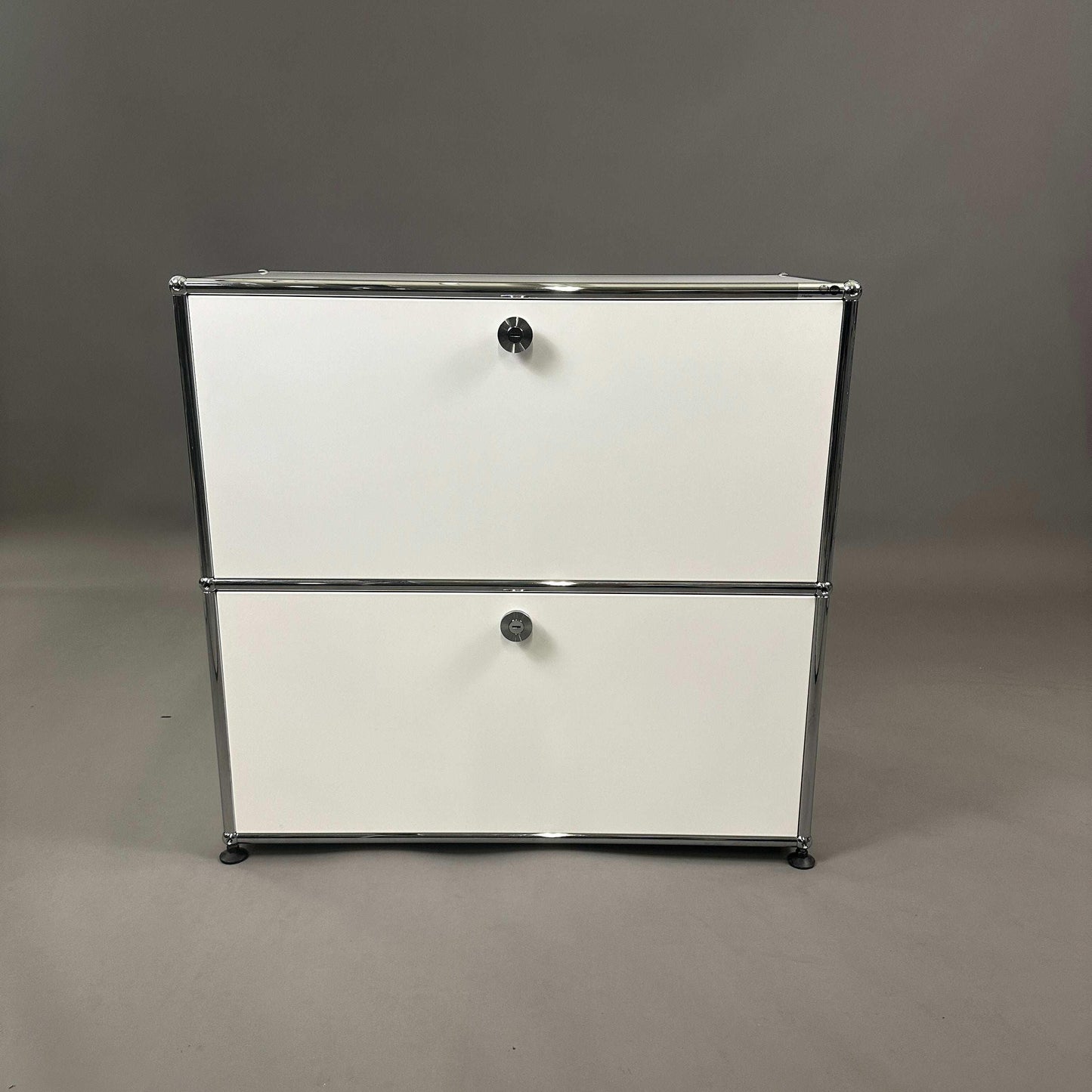 USM Haller white sideboard with two flap doors and chrome frame