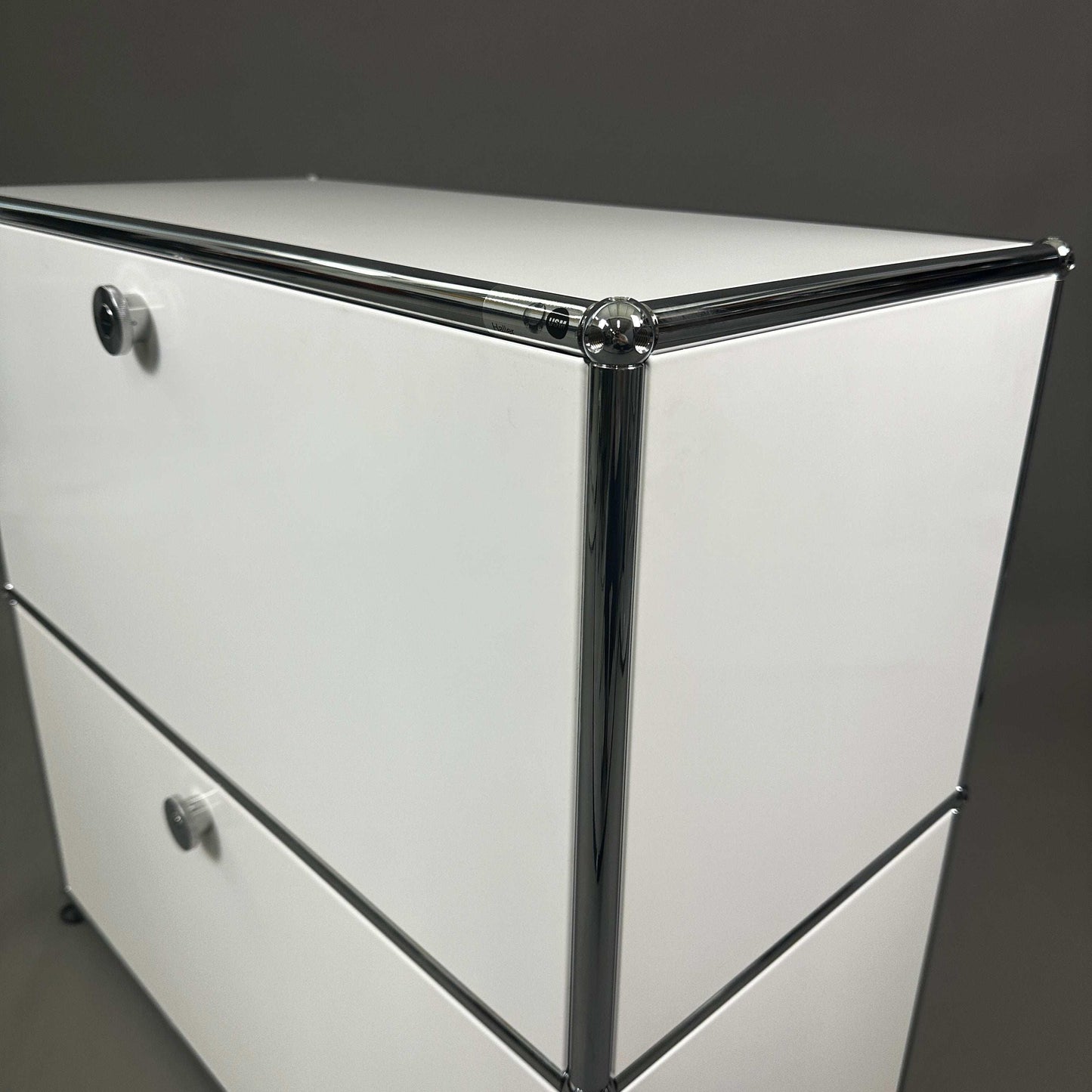 USM Haller white sideboard with 1x2 compartments and 2 flap doors, chrome frame, modern design