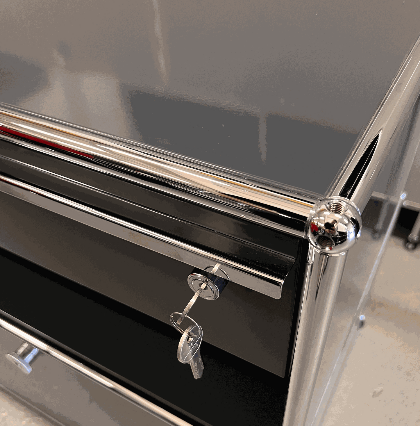 Close-up of anthracite USM Haller Sideboard with keys in lock and chrome frame detailing