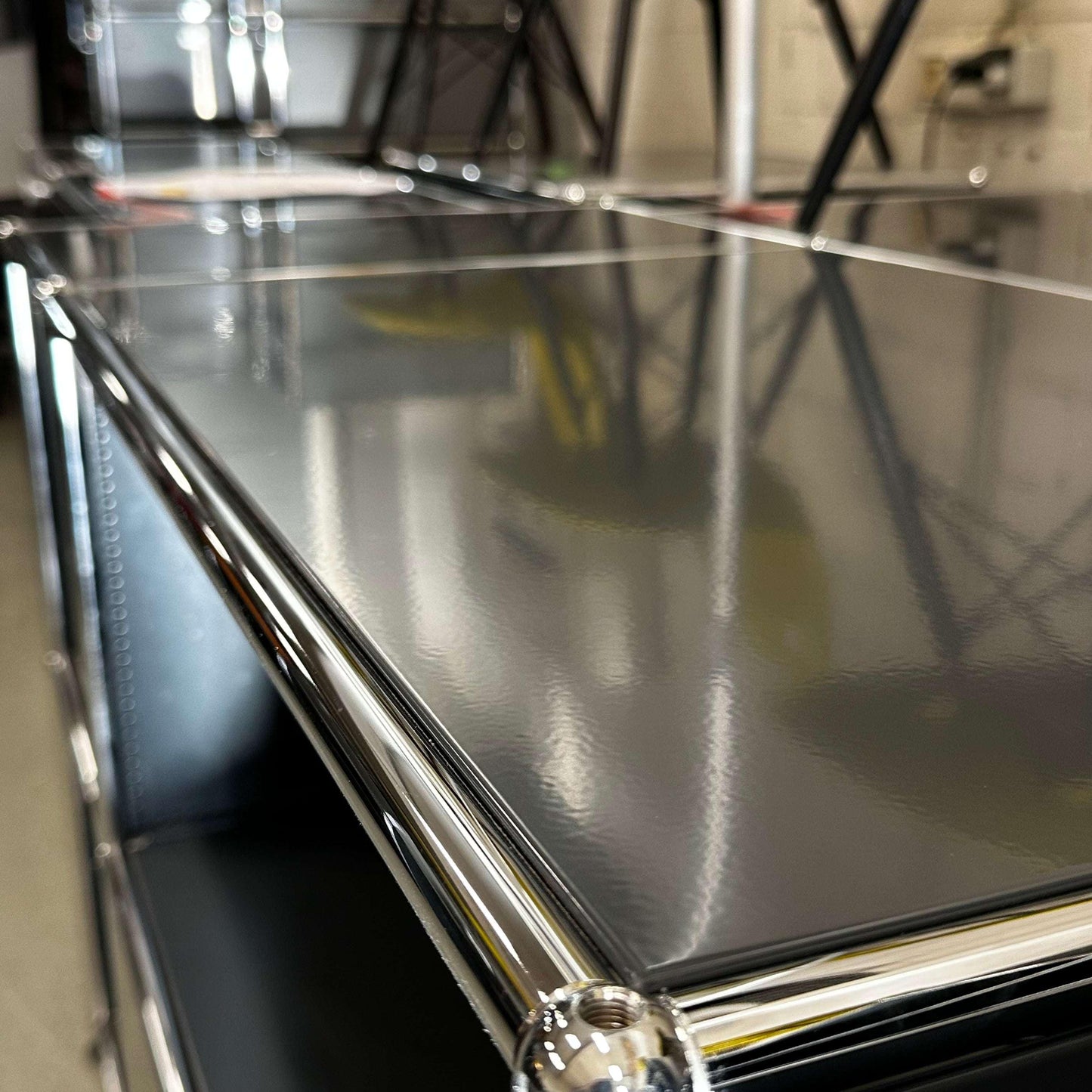 Close-up of anthracite USM Haller Sideboard with glossy surface and chrome metal frame detailing