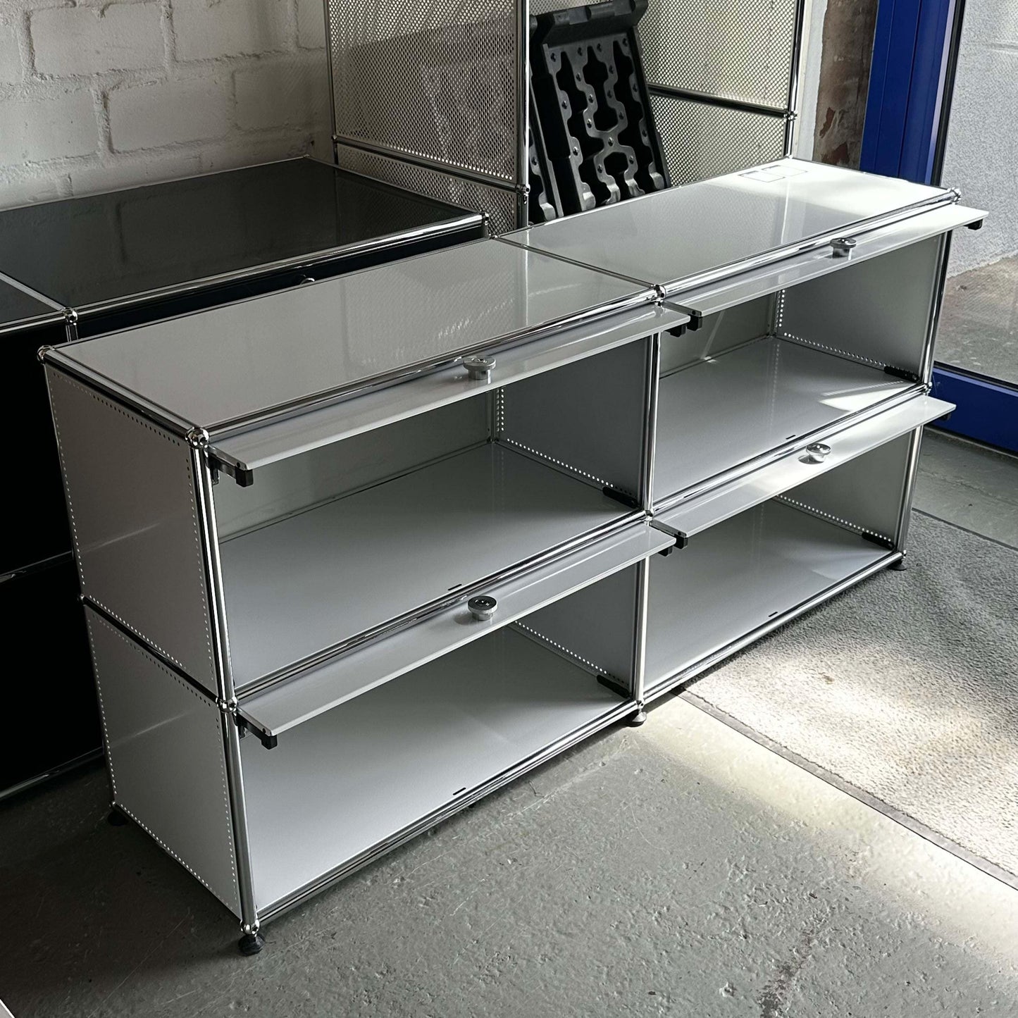 USM Haller light gray sideboard with 2x2 compartments and 4 drop-down doors, 152x74x37cm