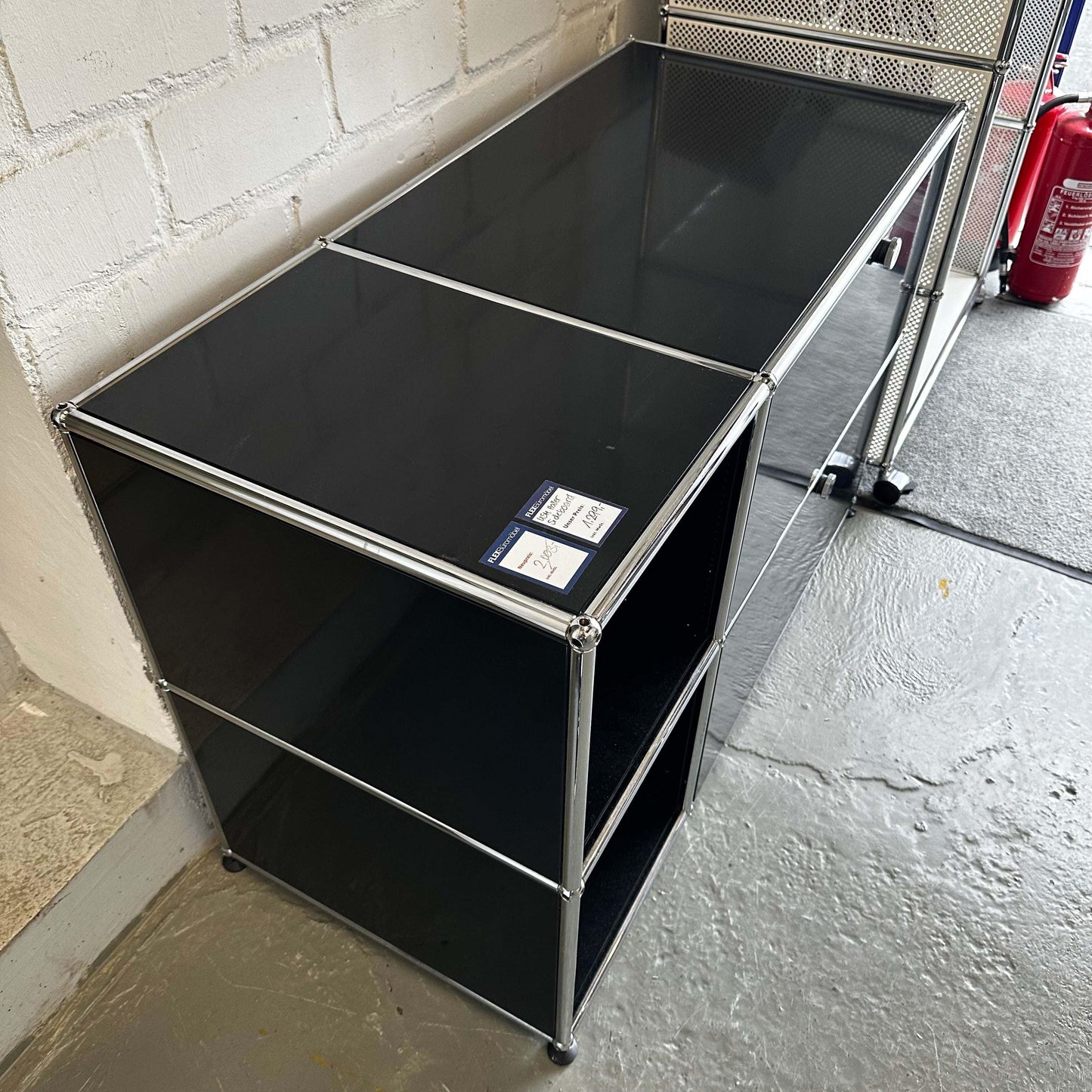Black USM Haller Sideboard with metal frame and glass top, dimensions 112.3x74x52.3 cm
