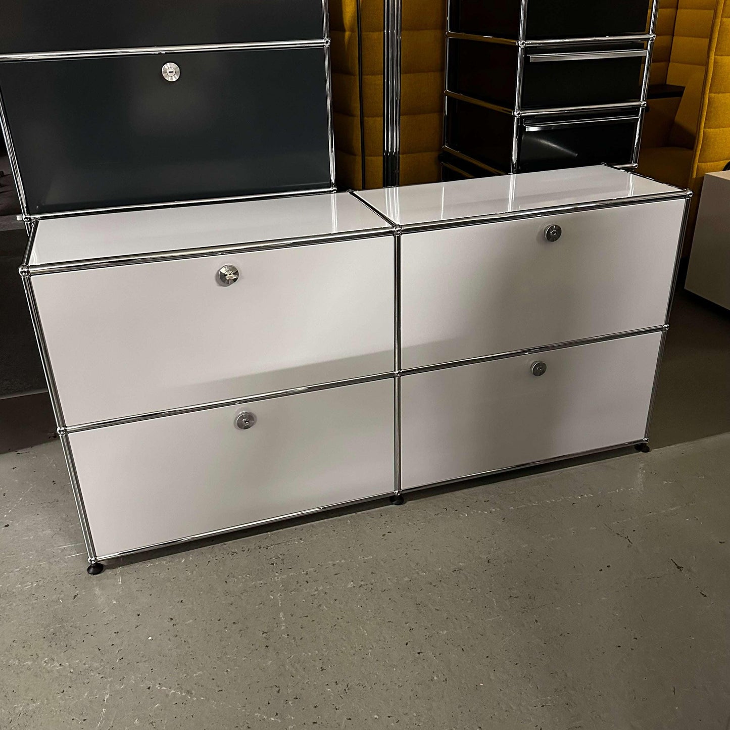 USM Haller Sideboard in light grey with four compartments and chrome frame design