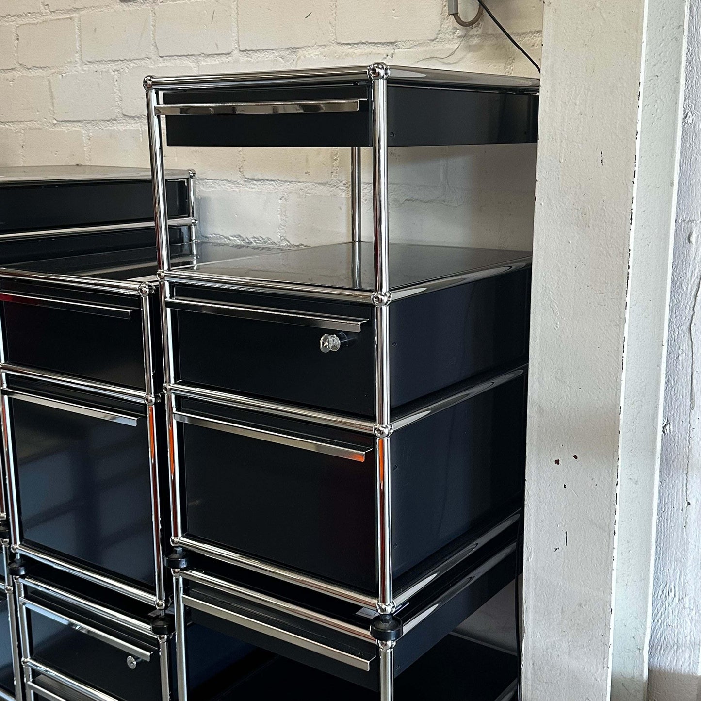 Black USM Haller stand container with three drawers and chrome frame