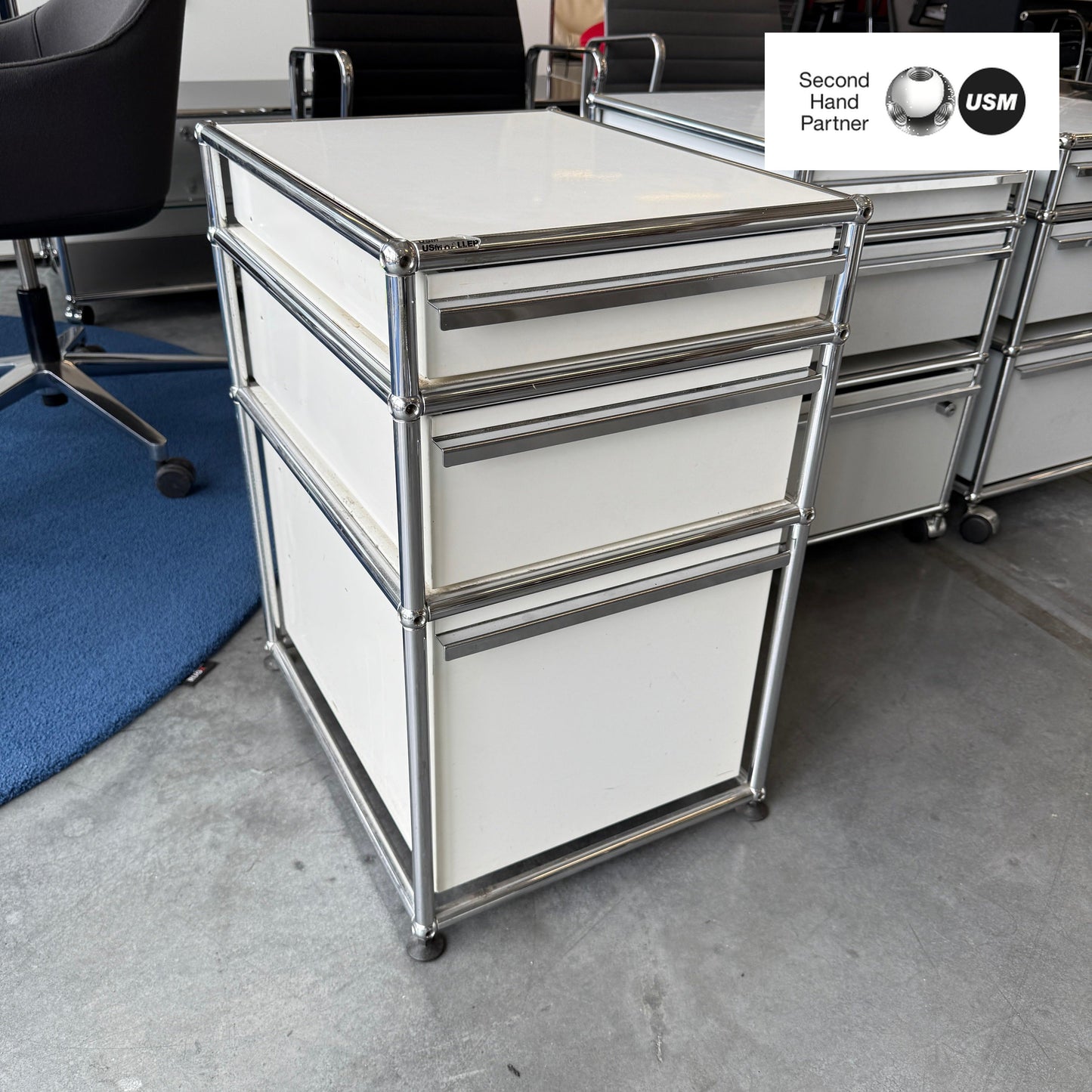 USM Haller white standcontainer with three drawers and chrome frame in office setting