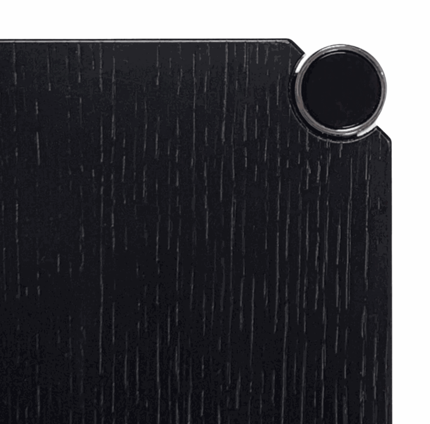 Close-up of black lacquered oak wood surface with chrome detail on USM Haller Tisch table