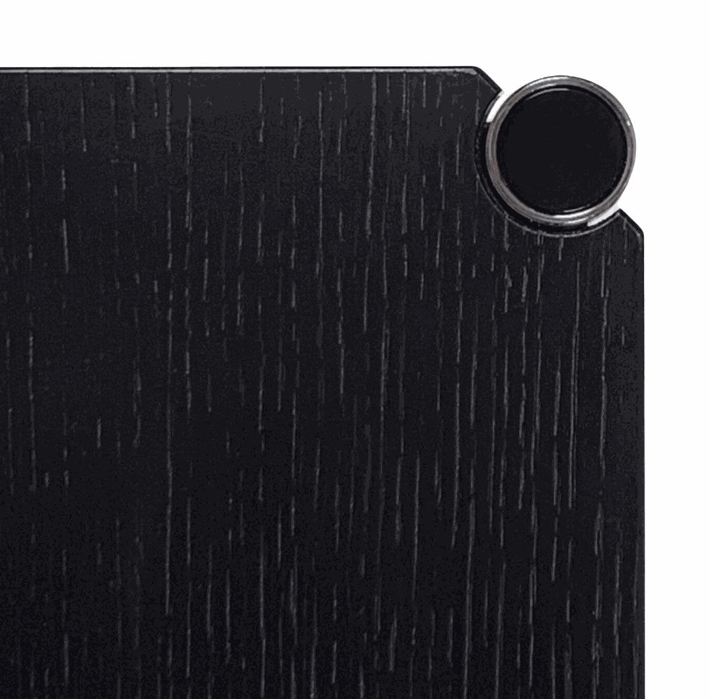 Close-up of black oak tabletop with chrome connector corner of USM Haller Tisch 75x75cm