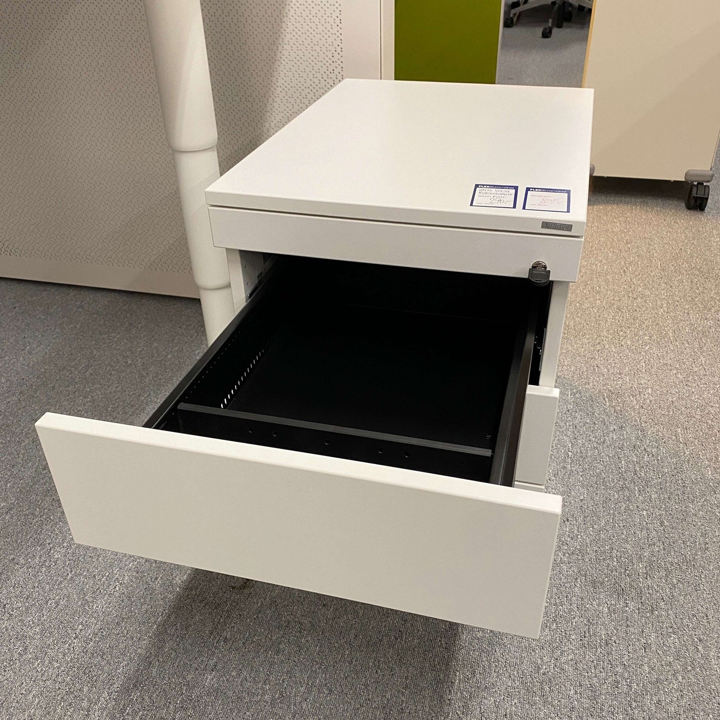 White Vario Versa Rollcontainer with four drawers, one open, on office carpet