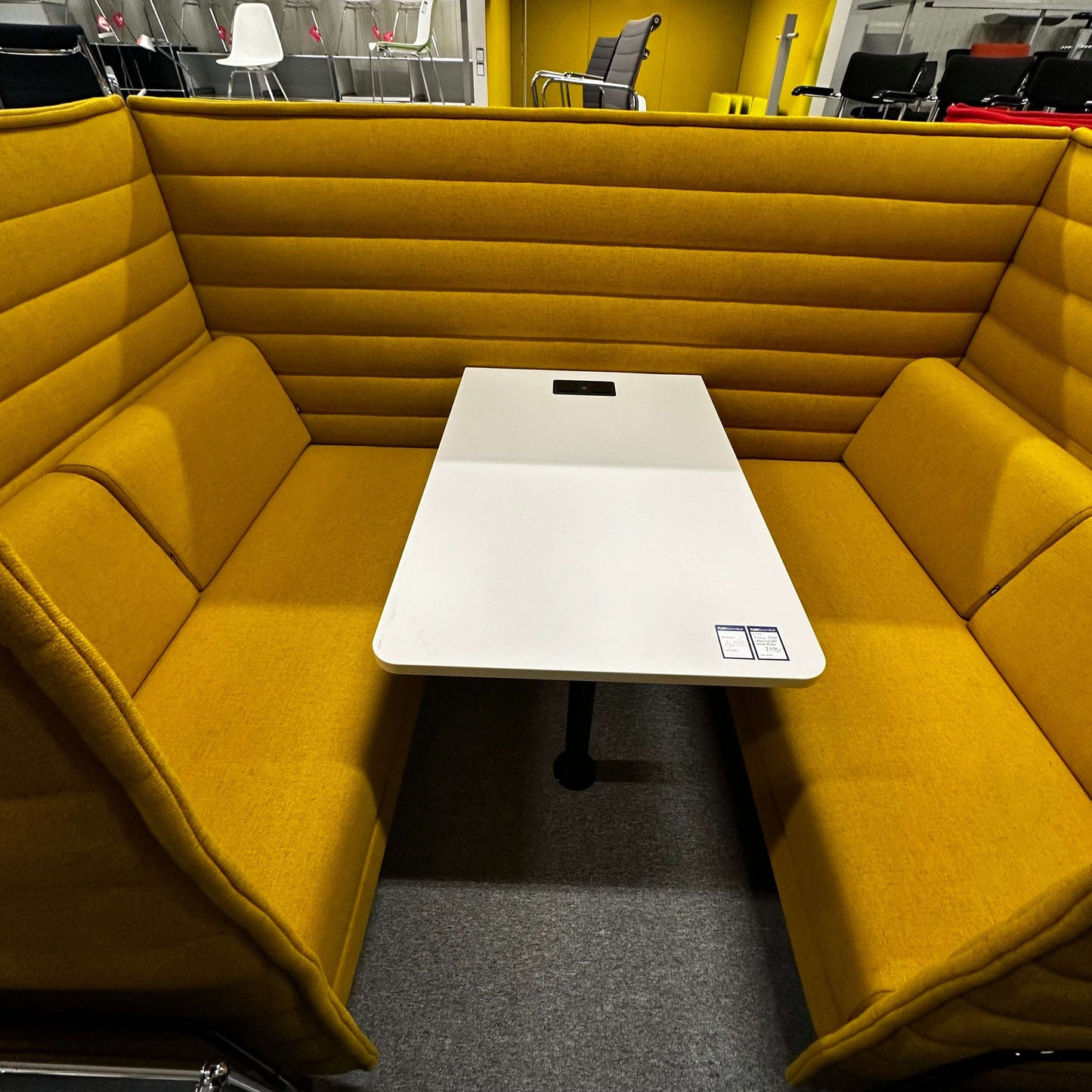Vitra Alcove Cabin Highback with mustard yellow upholstery and white worktable in office setting