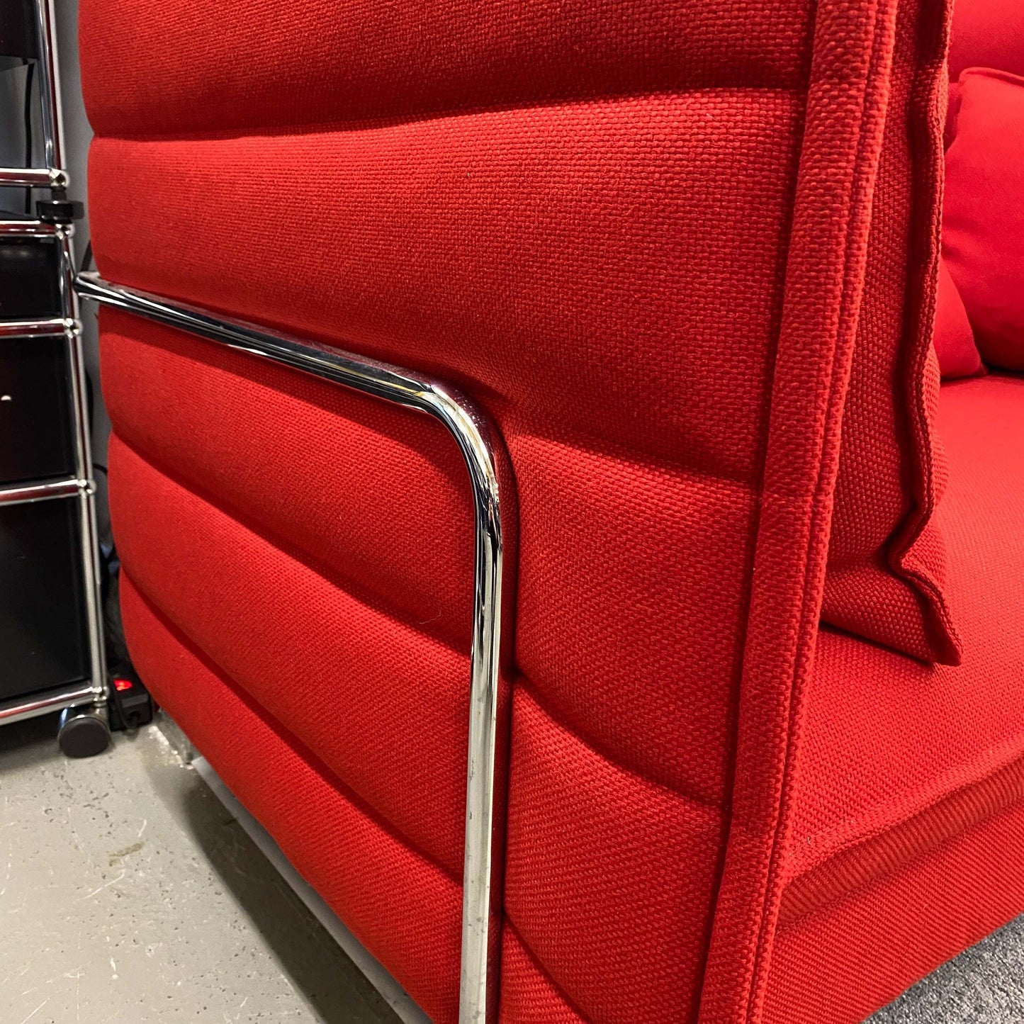 Vitra Alcove Lowback Love Seat in red fabric with chrome frame close-up detail