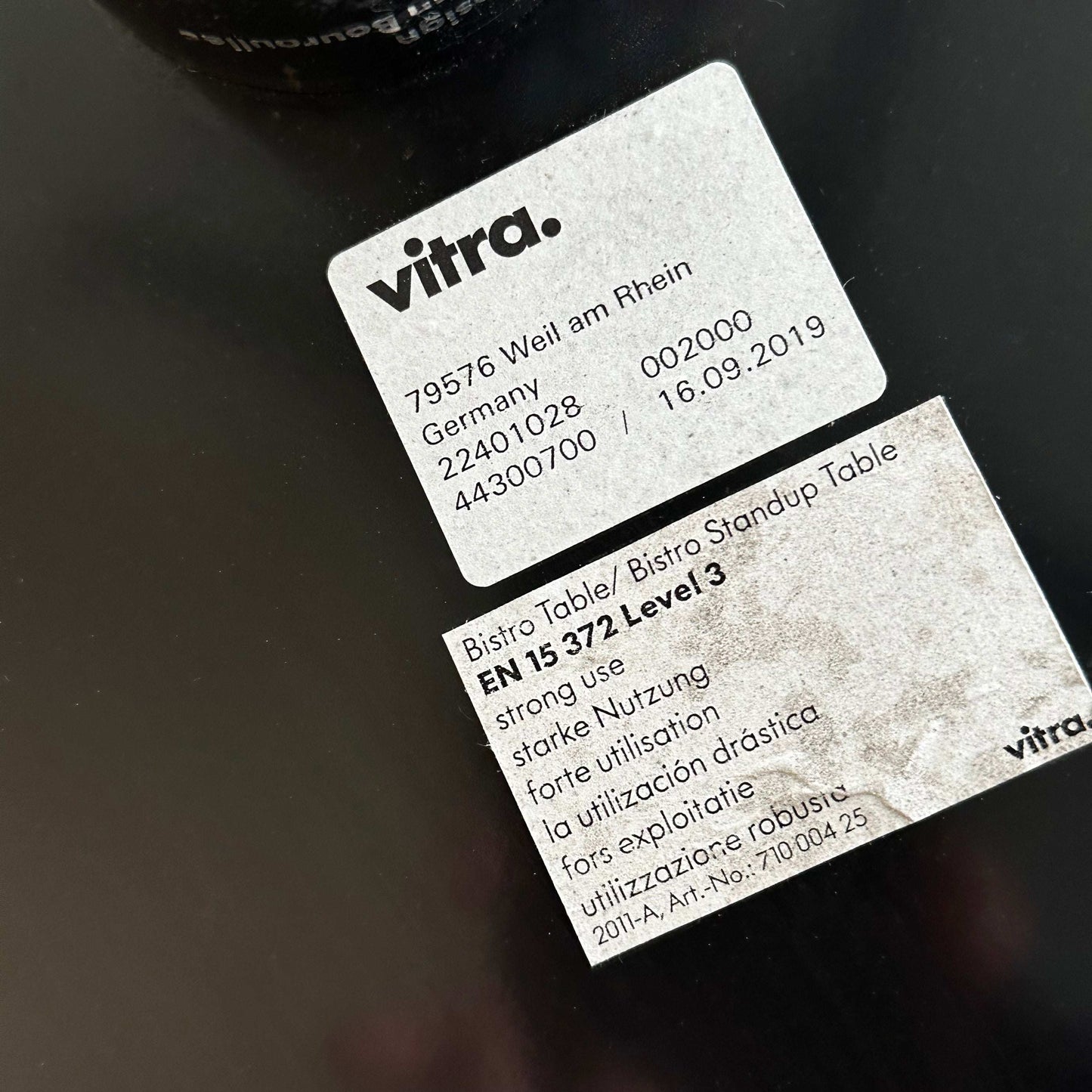 Close-up of Vitra Bistro Table labels indicating model details and strong use certification