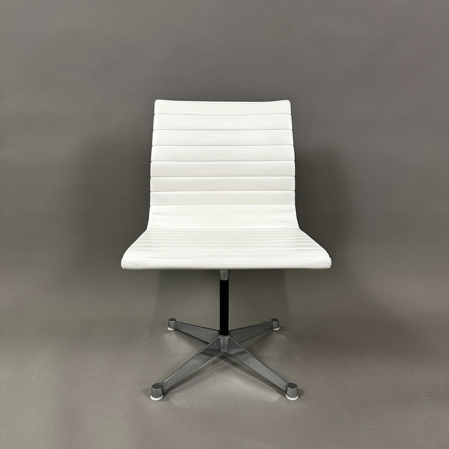 Vitra EA 101 white leather chair with aluminum non-swivel base and no armrests
