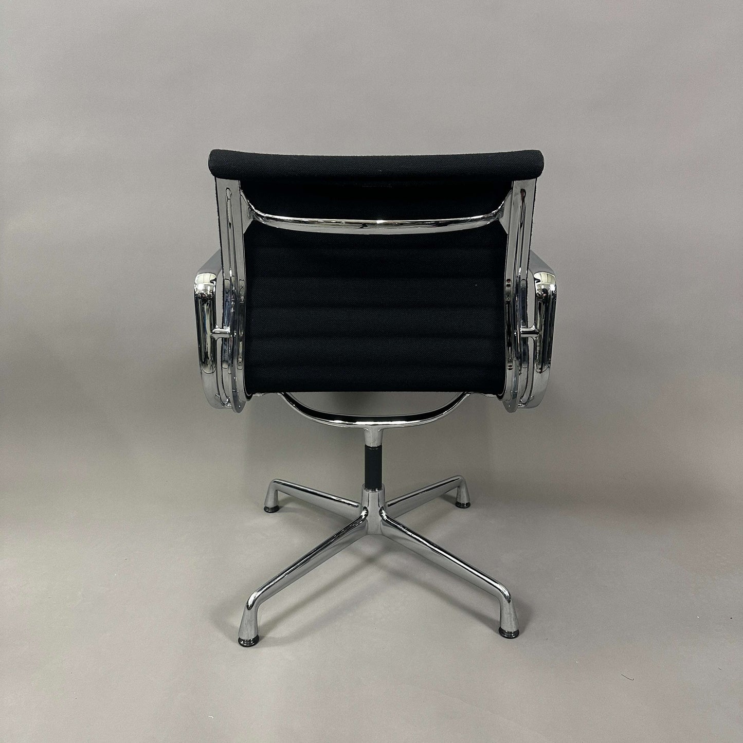 Vitra EA 108 black Hopsak fabric office chair with chrome frame and swivel base viewed from the back