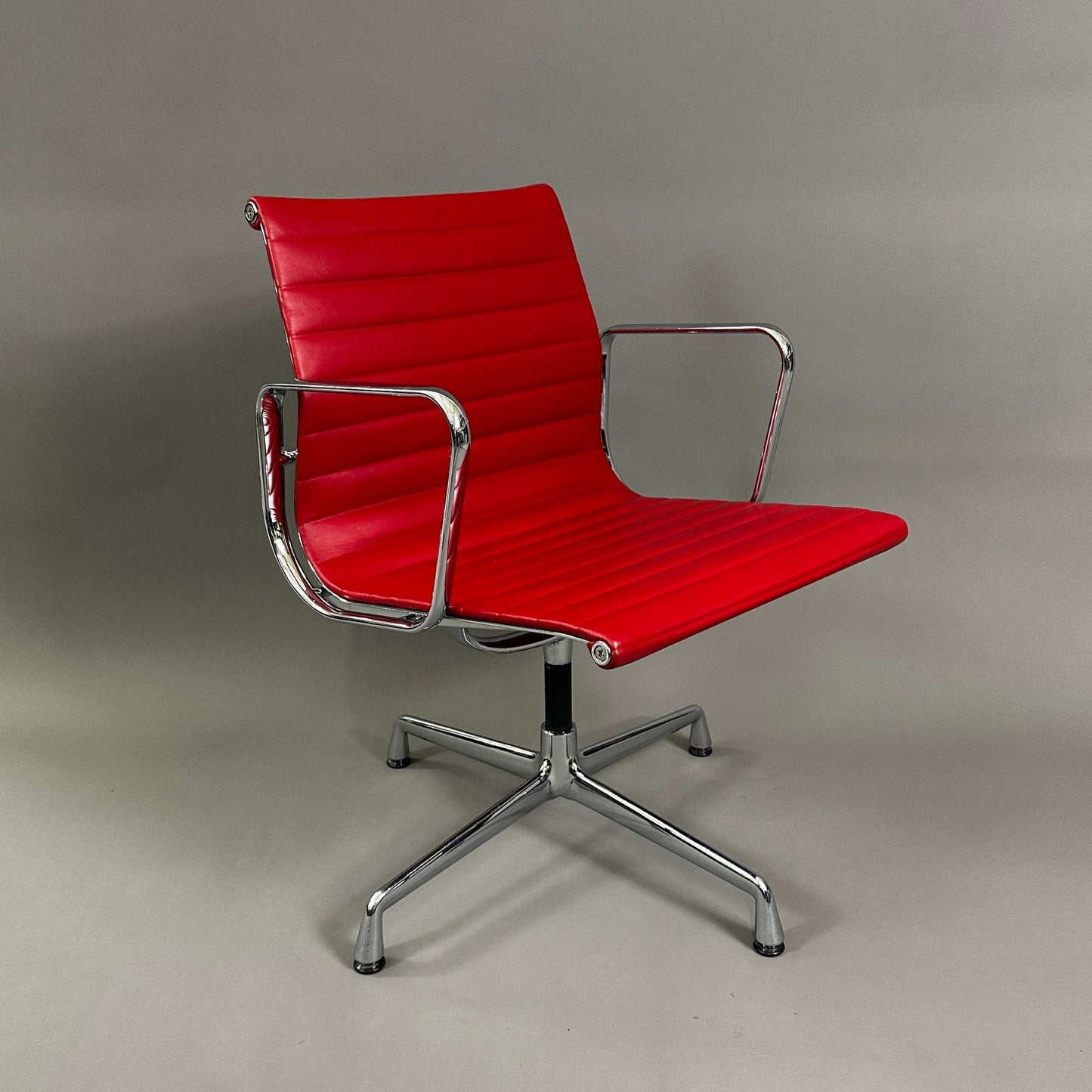 Red leather Vitra EA 108 swivel chair with chrome frame
