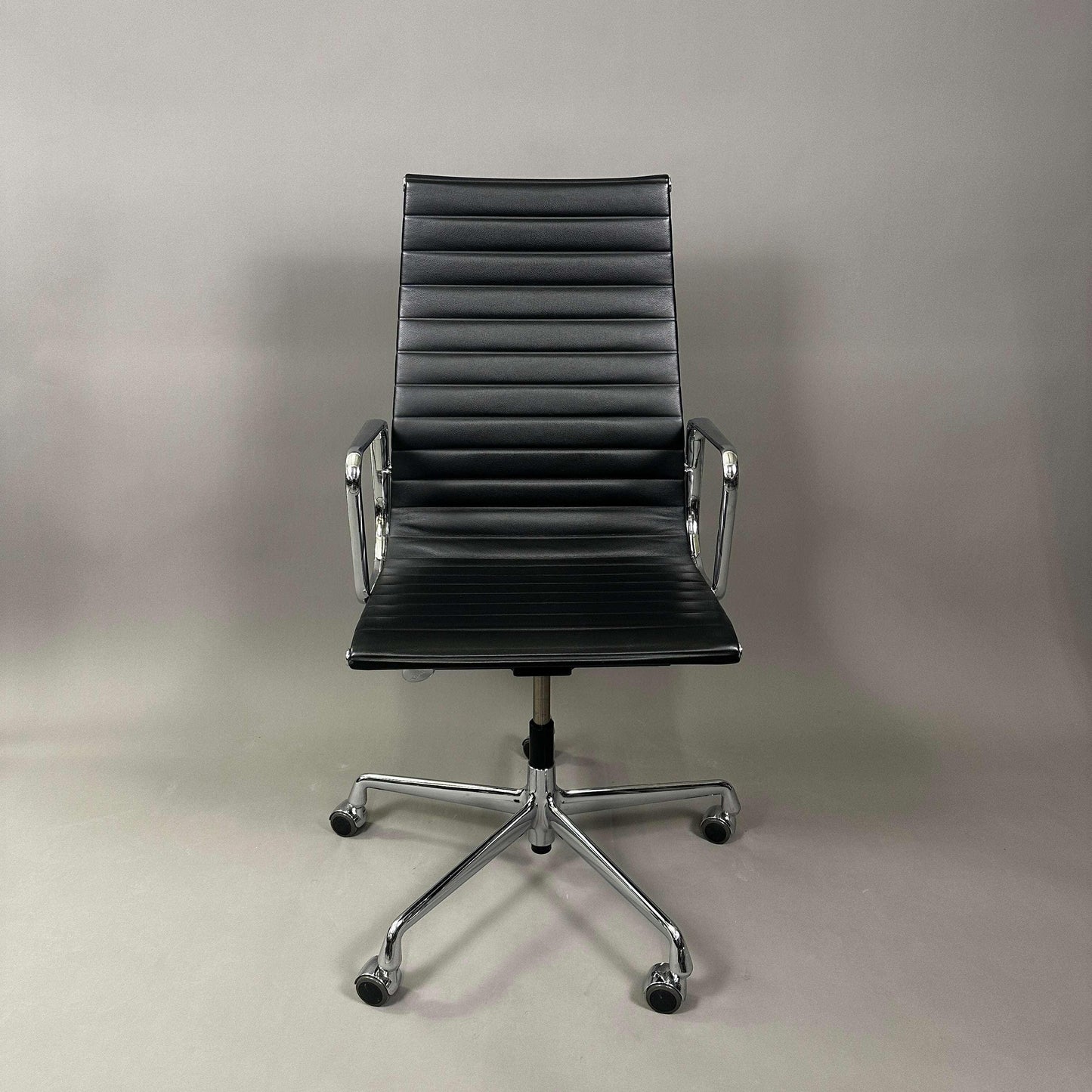 Vitra EA 119 black leather office chair with chrome frame and adjustable tilt function