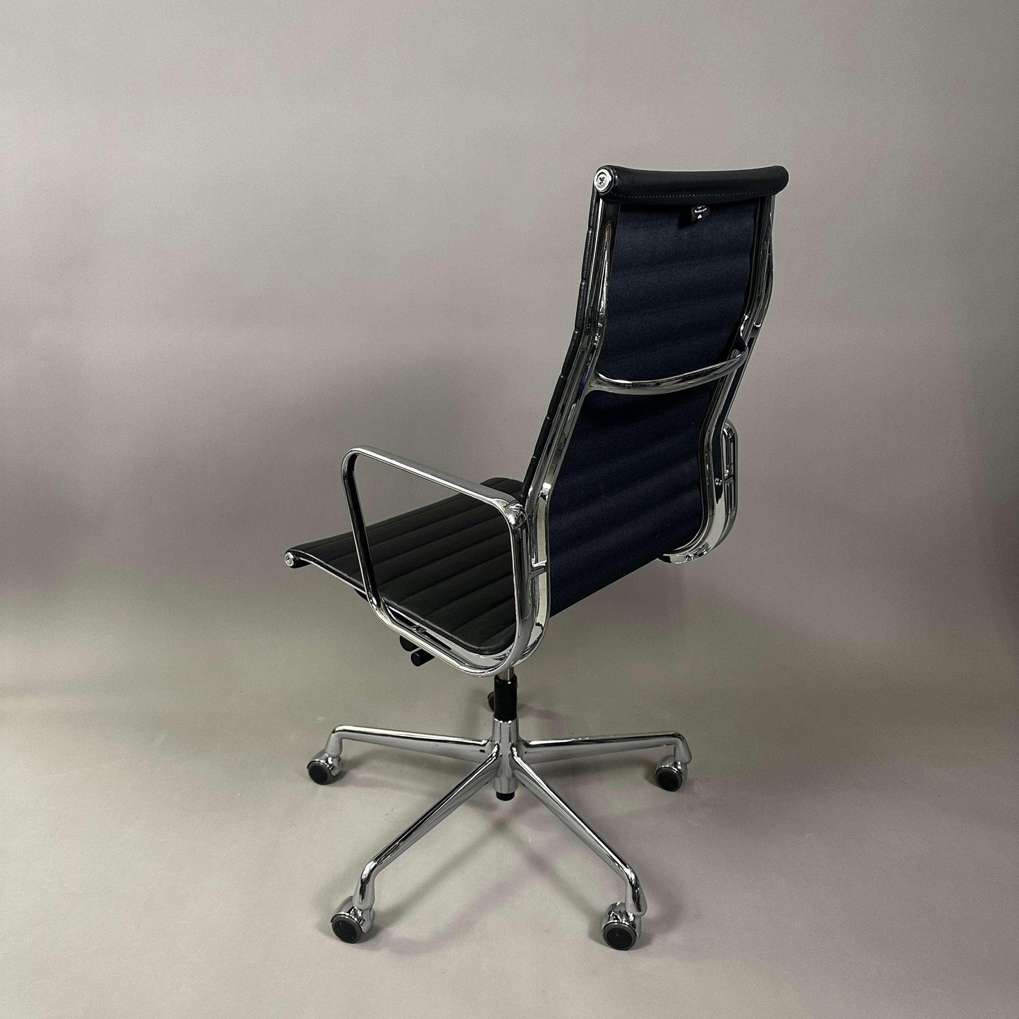 Vitra EA 119 office chair in black leather with chrome frame and adjustable tilt function