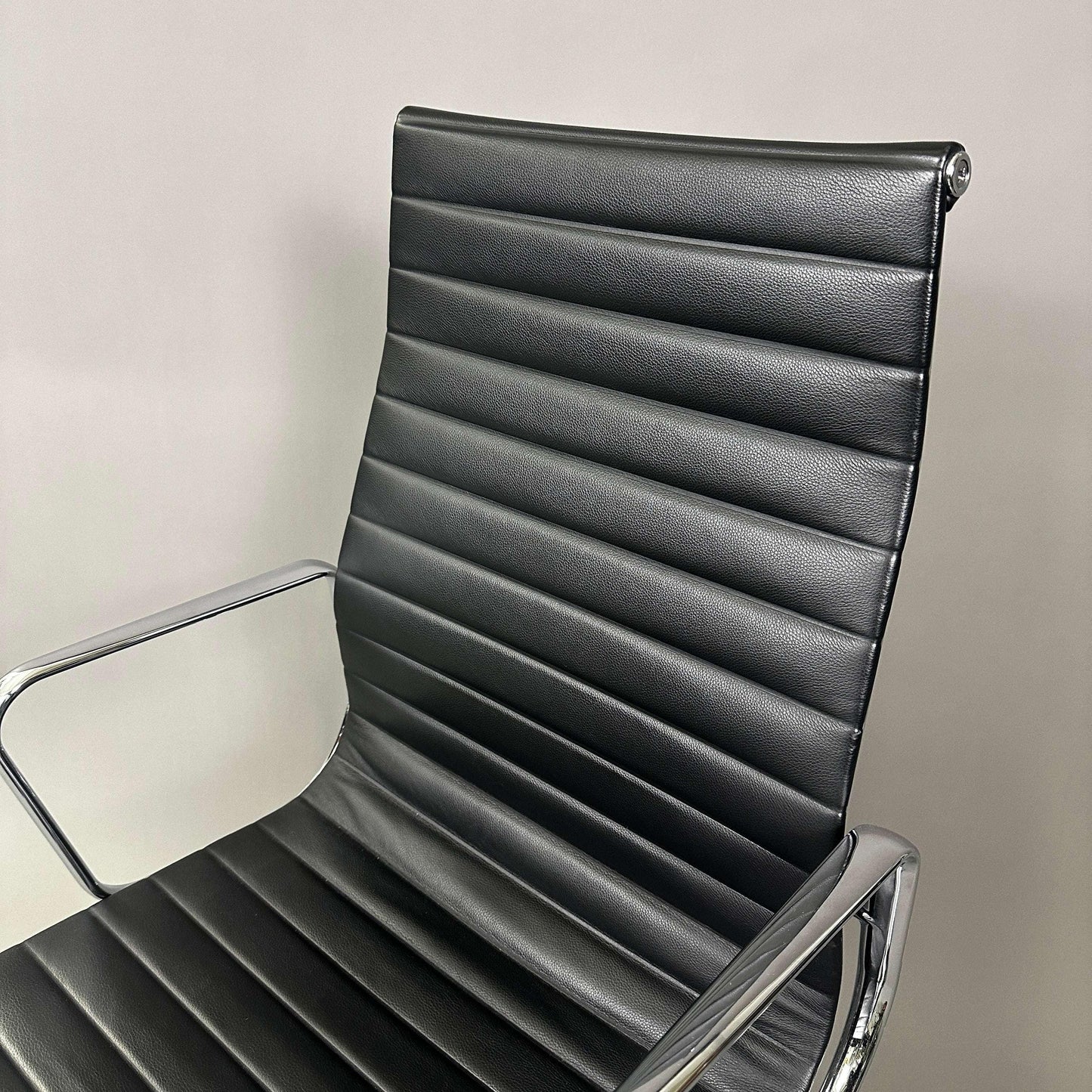 Vitra EA 119 black leather office chair with chrome frame and adjustable tilt function