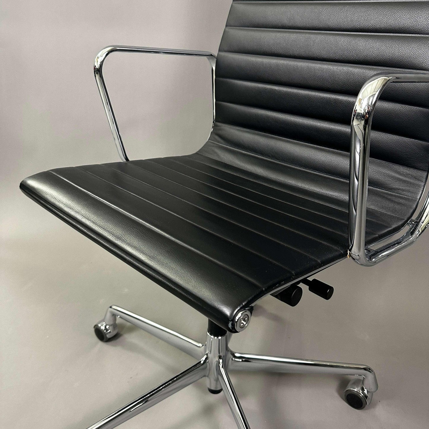 Vitra EA 119 office chair with black leather seat and chrome frame