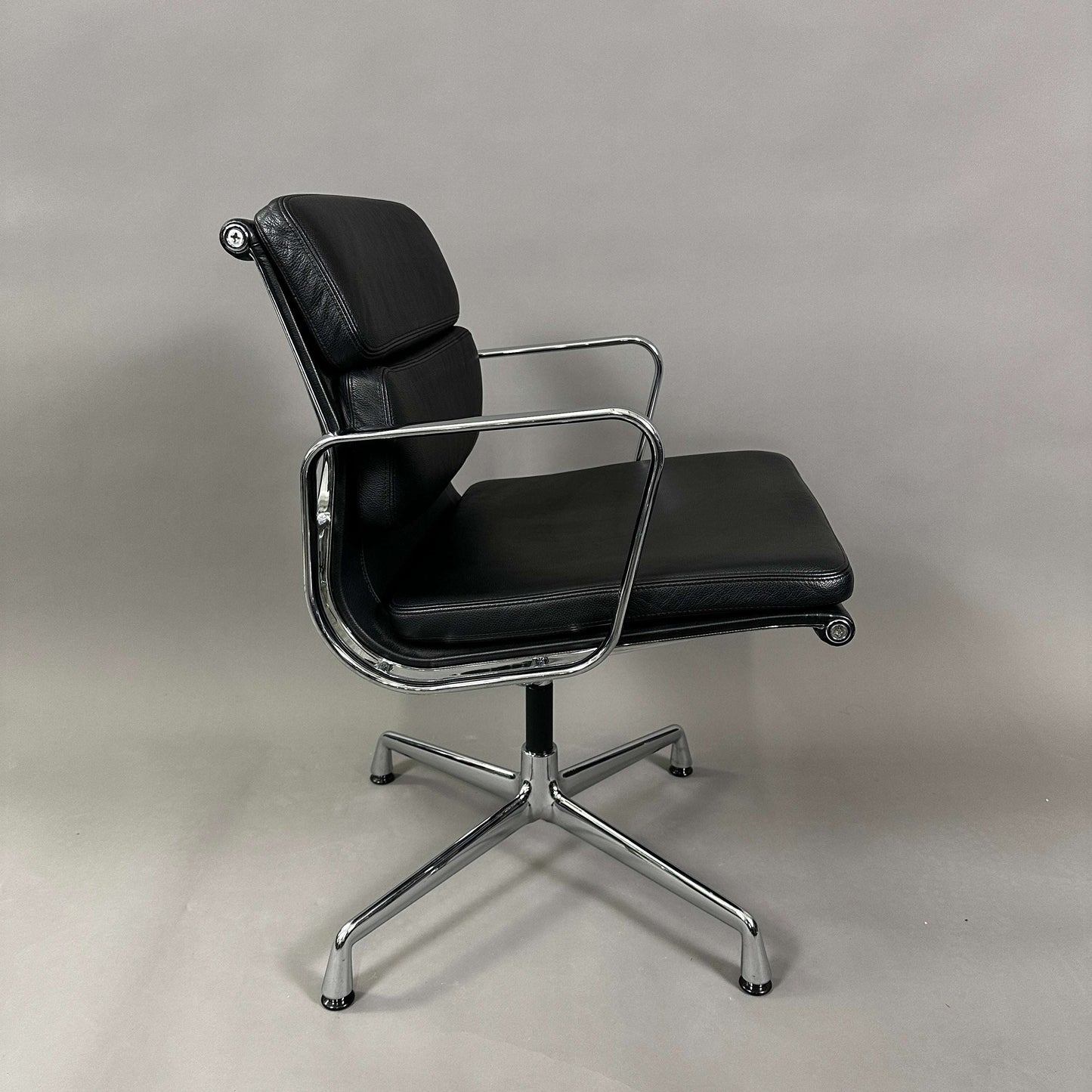 Vitra EA 208 black leather soft pad chair with chrome frame and swivel base