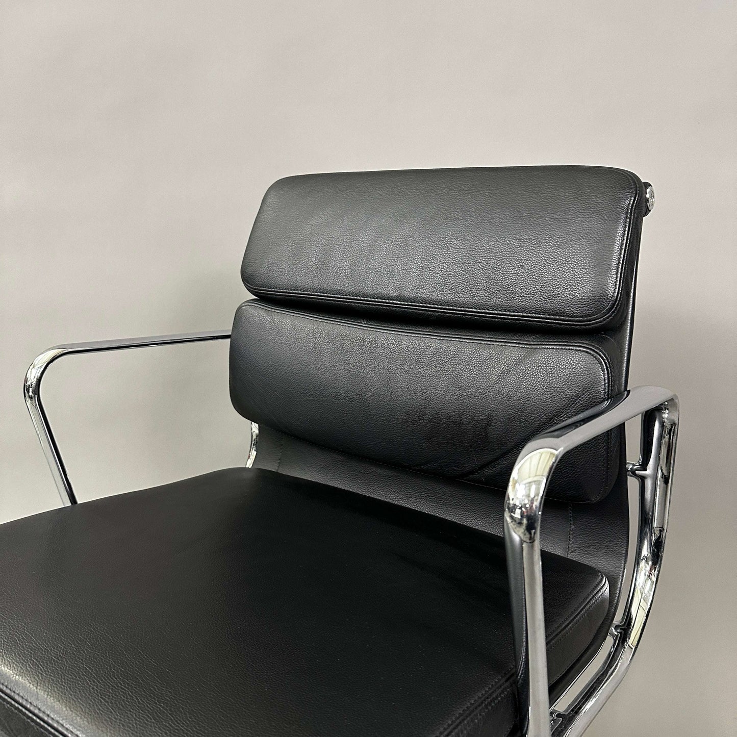 Vitra EA 208 black leather soft pad chair with chrome frame and swivel base