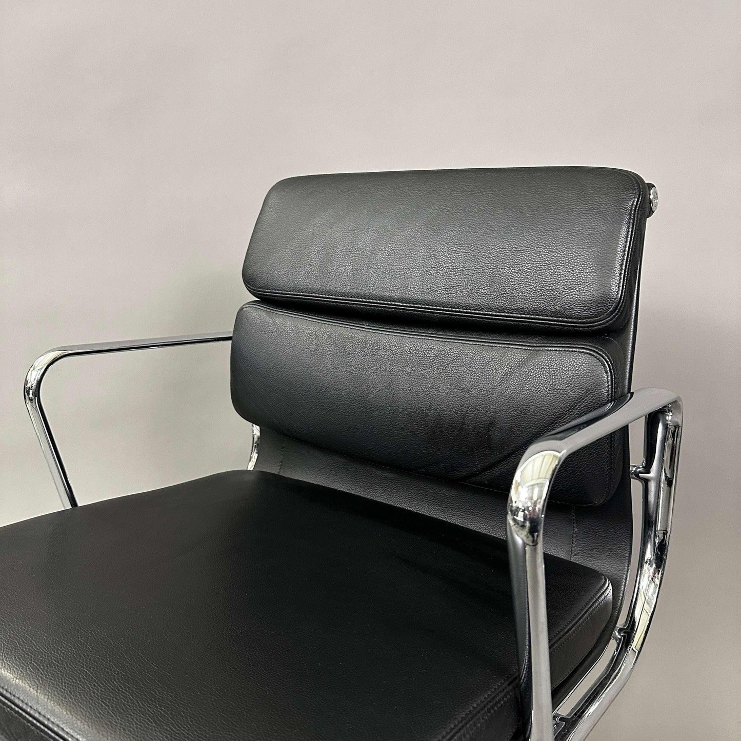 Vitra EA 208 black leather soft pad chair with chrome frame and swivel base