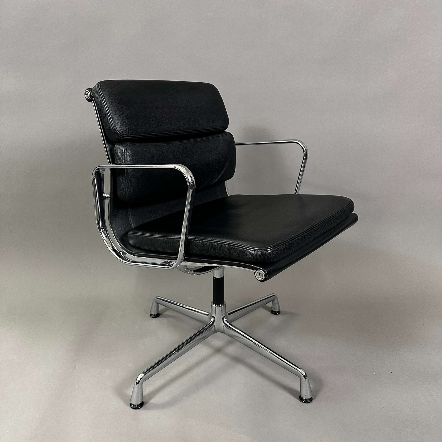 Black Vitra EA 208 Soft Pad Chair with padded leather seat and chrome swivel frame