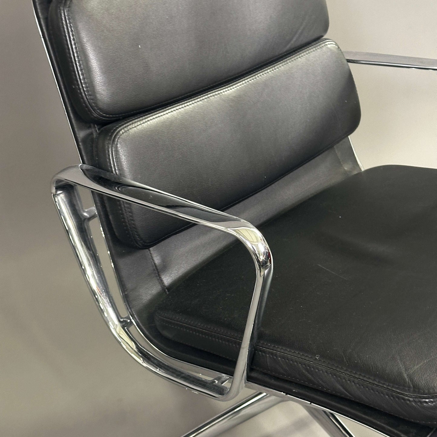 Vitra EA 216 black soft pad leather office chair with chrome armrests and swivel base