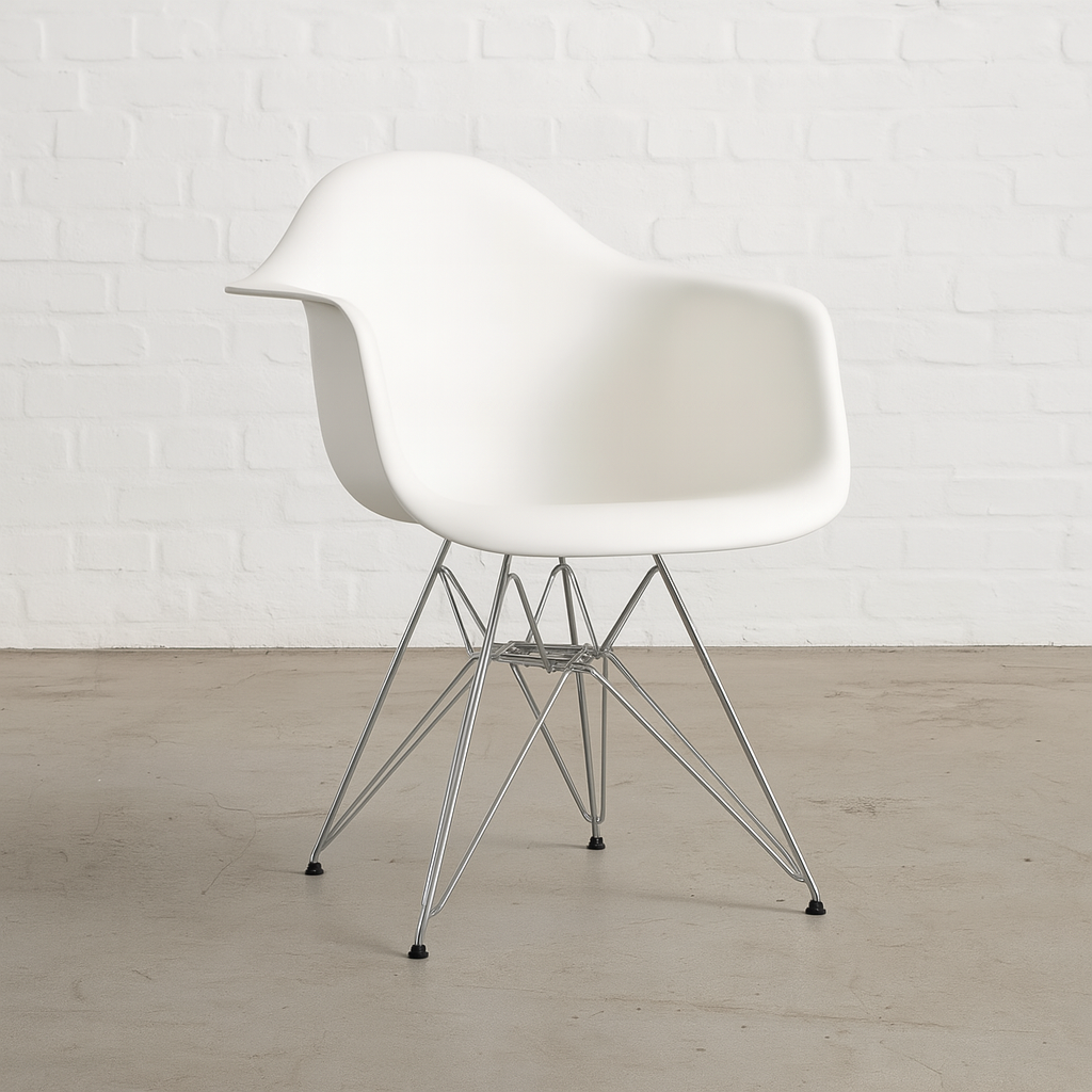 Vitra Eames Plastic Armchair DAR in white with metal legs against white brick wall background