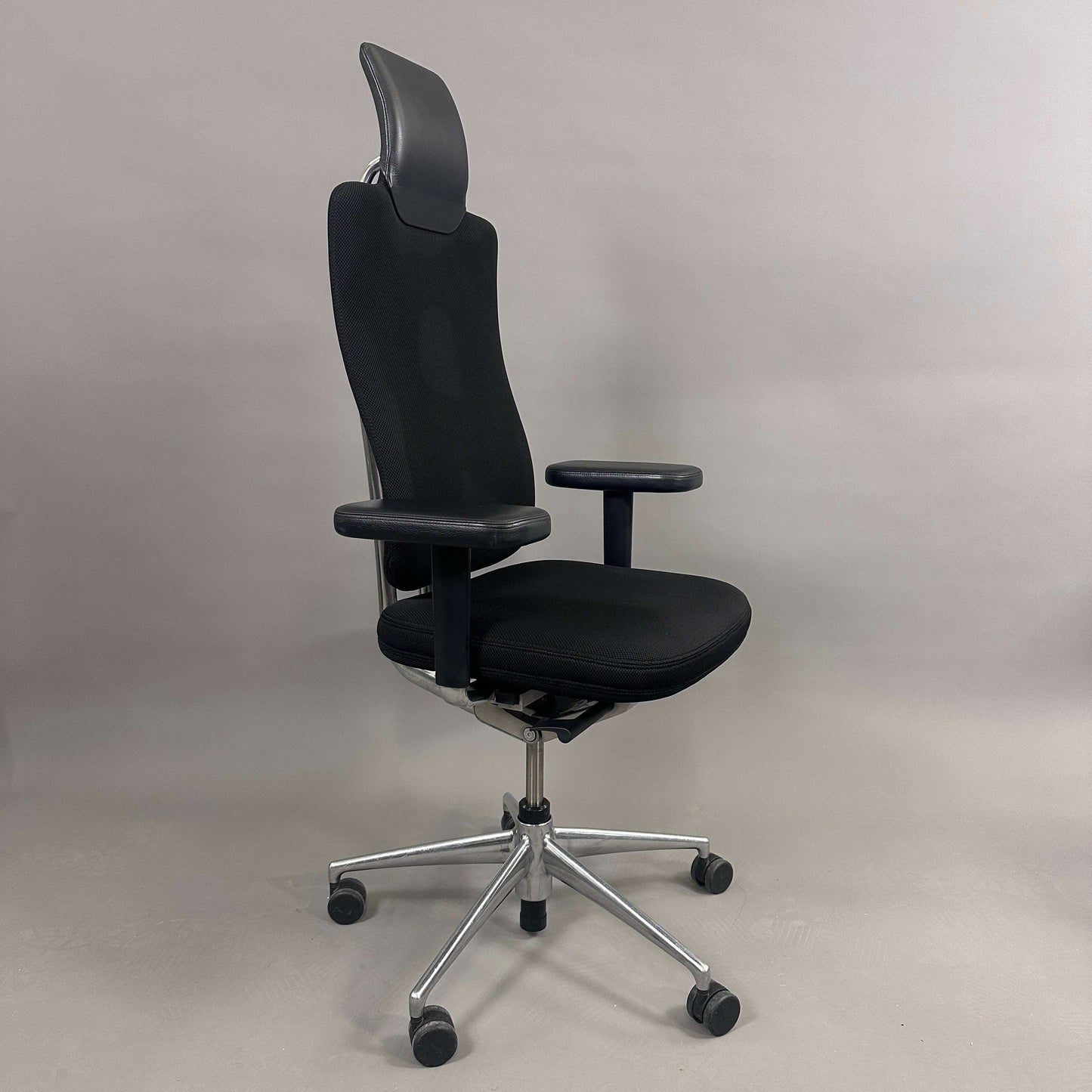 Vitra Headline black office chair with fabric seat, leather headrest, adjustable armrests, and chrome base