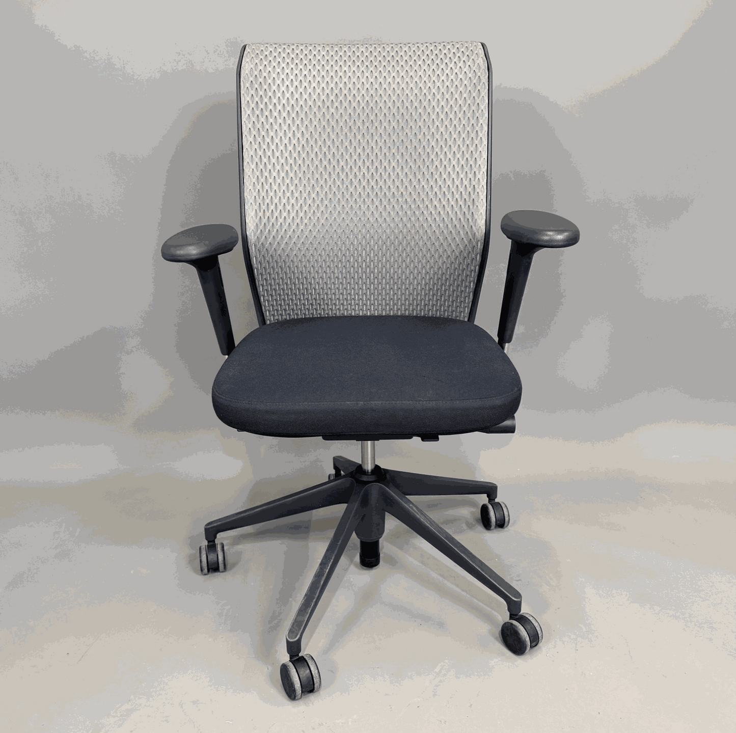 Vitra ID Mesh ergonomic office chair with grey mesh backrest, black seat, adjustable 3D armrests, and lumbar support