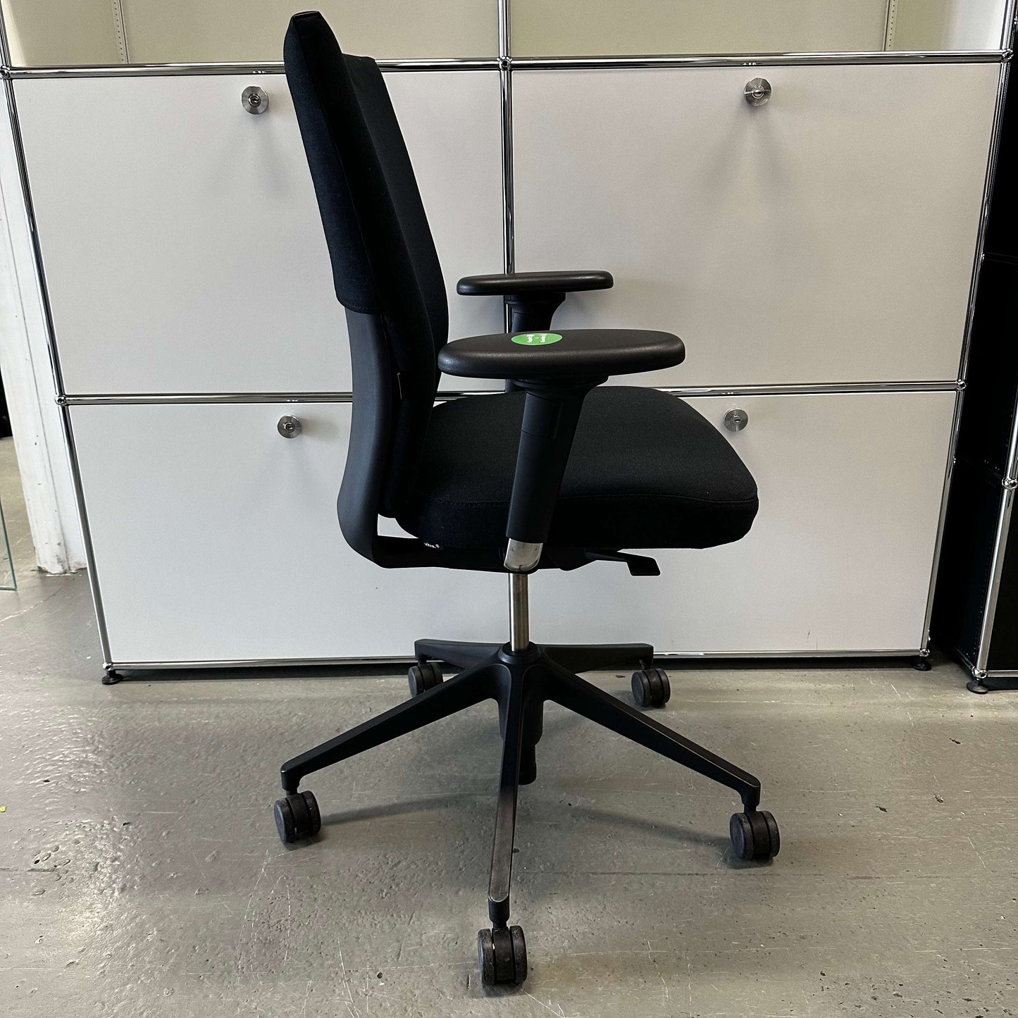 Black Vitra ID Soft ergonomic office chair with fabric upholstery and plastic base on wheels