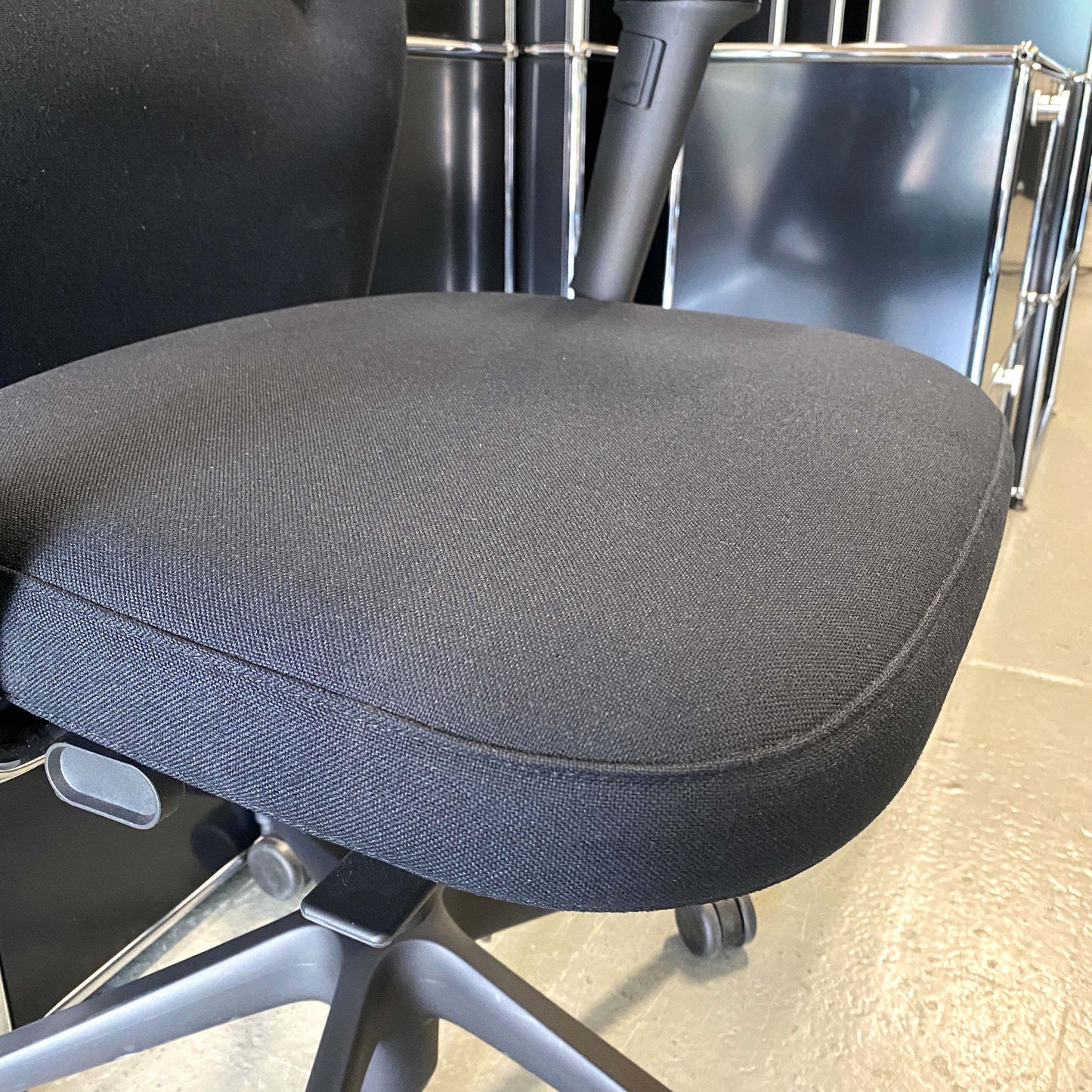 Vitra ID Trim L ergonomic black office chair with adjustable seat and armrests, fabric seat and leather headrest