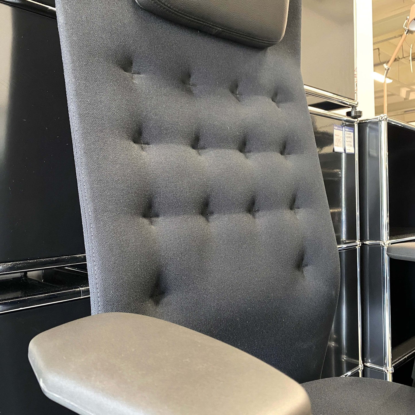 Adjustable Vitra ID Trim L office chair with black fabric seat and leather headrest