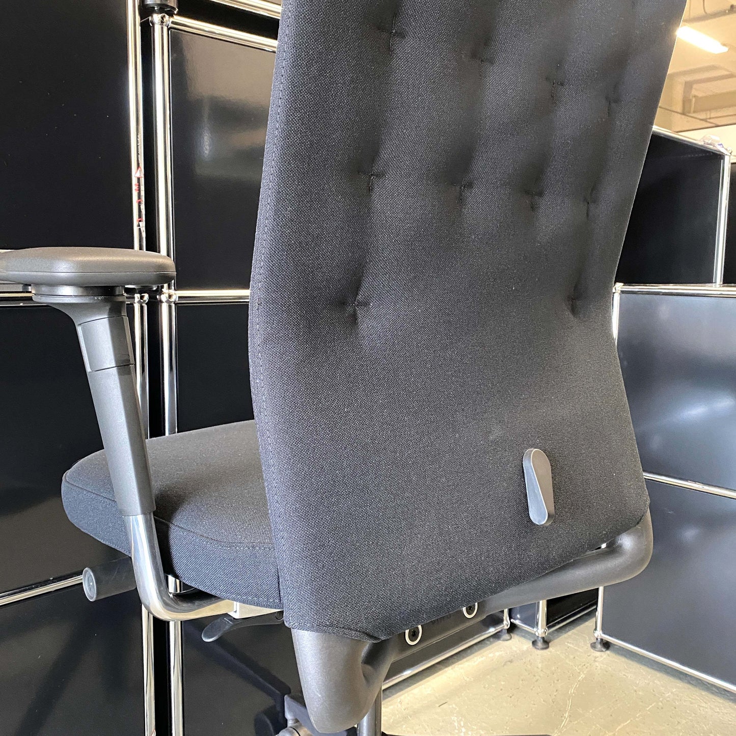 Adjustable black Vitra ID Trim L office chair with fabric seat and leather headrest, ergonomic armrests and lumbar support