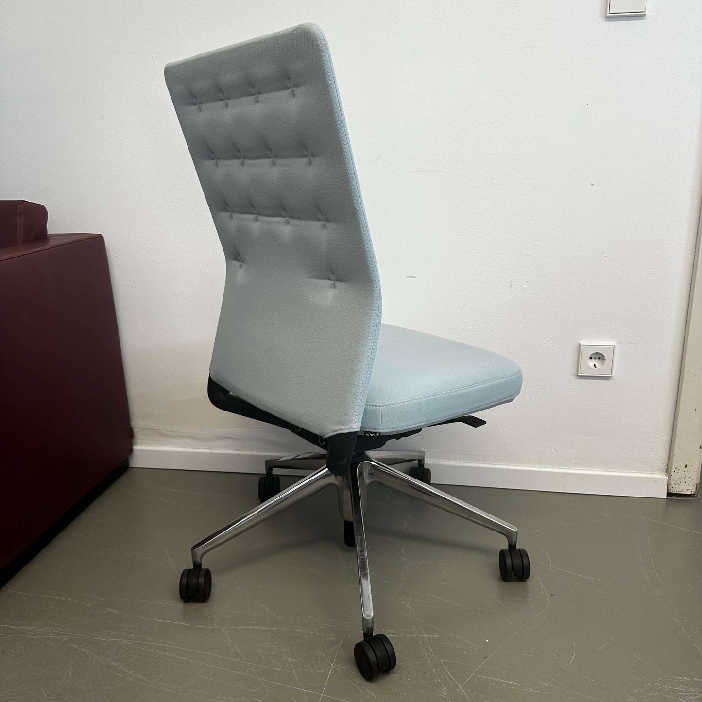 Light blue Vitra ID Trim office chair with adjustable lumbar support and casters