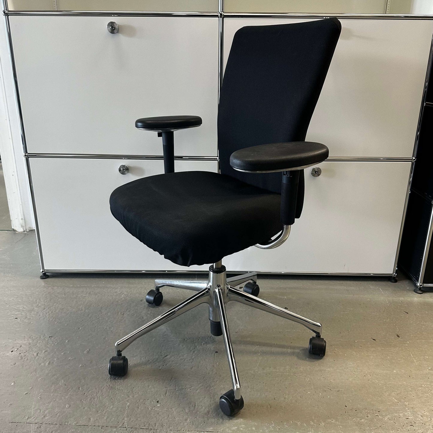 Black Vitra T-Chair office chair with adjustable armrests and metal base on wheels