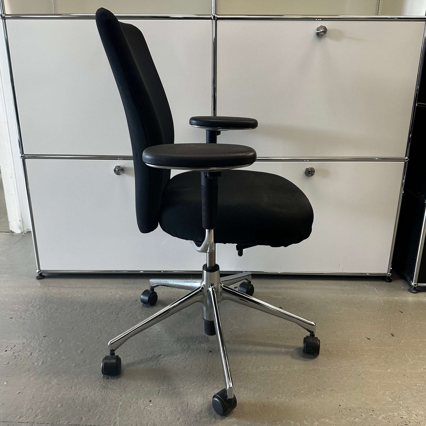 black Vitra T-Chair office chair with adjustable armrests and chrome base on wheels