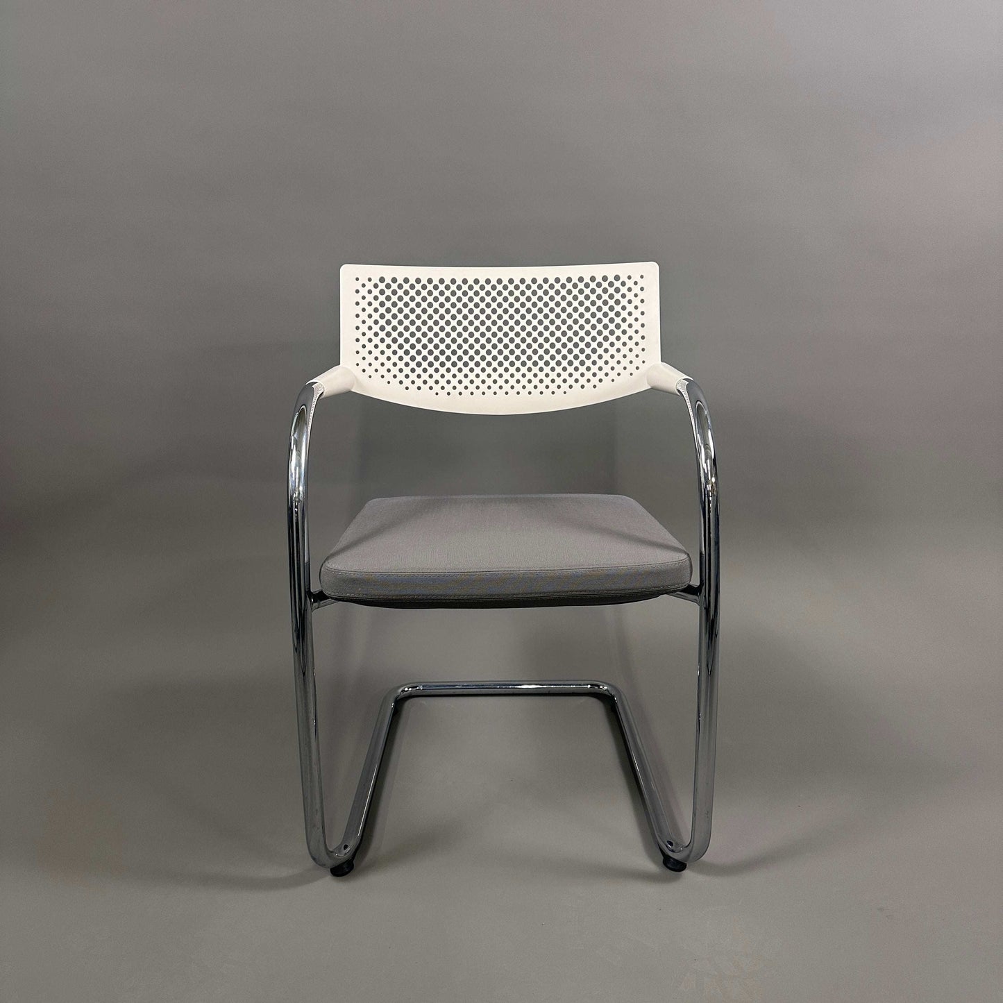 Vitra Visavis 2 chair with gray upholstered seat, white perforated plastic backrest, and chrome frame