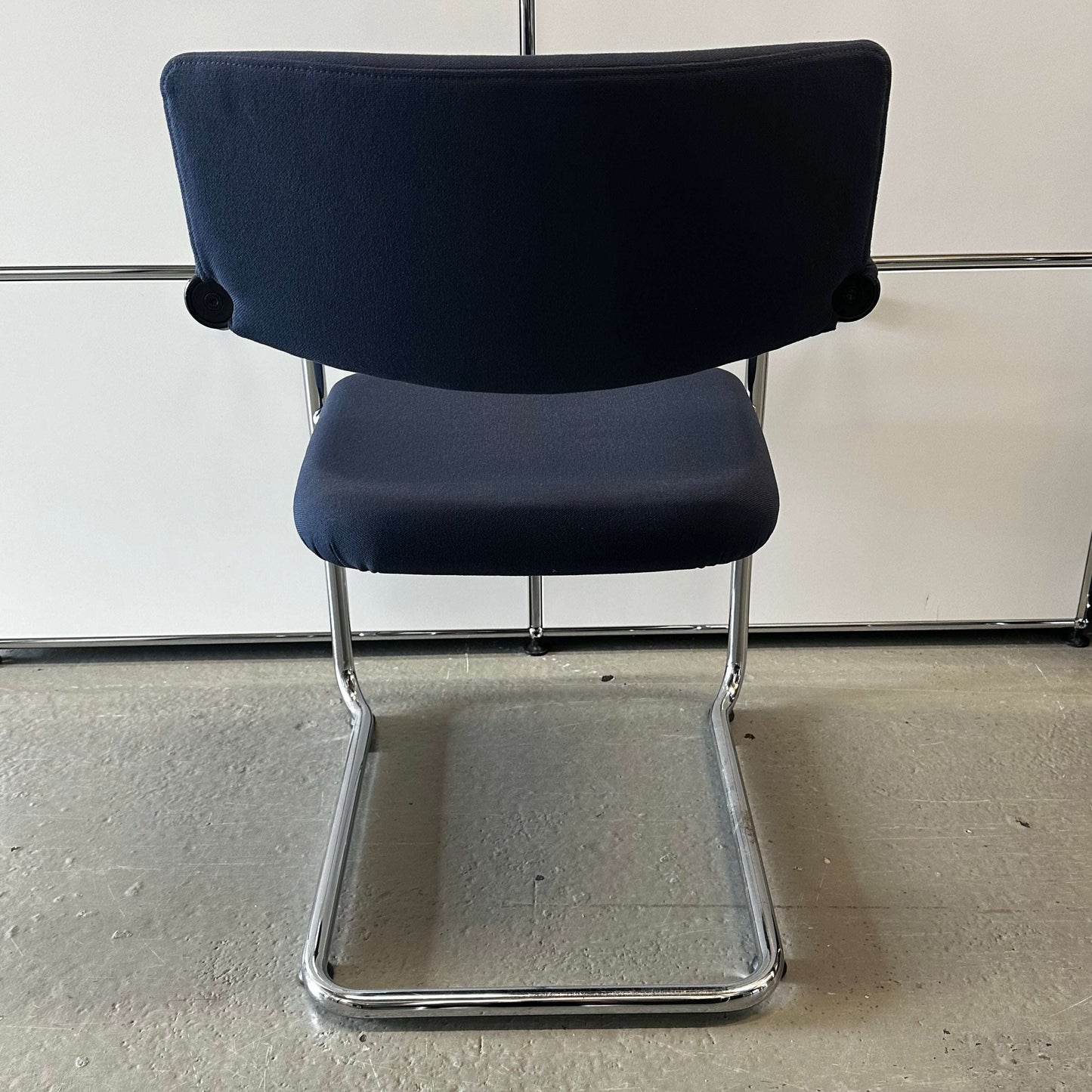 Vitra Visavis Softback chair in dark blue with padded backrest and chrome cantilever frame
