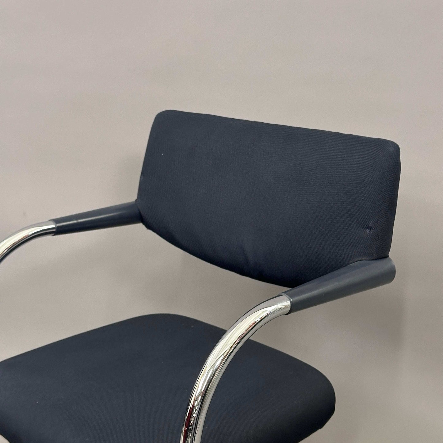 Vitra Visavis Softback black fabric chair with chrome frame and plastic armrests, padded backrest, cantilever and stackable design