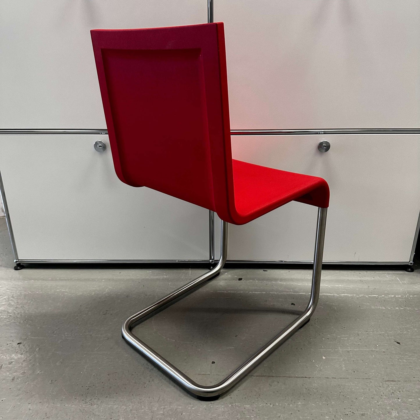 Vitra .05 Maarten van Severen chair in signal red with stainless steel frame and polyurethane seat shell