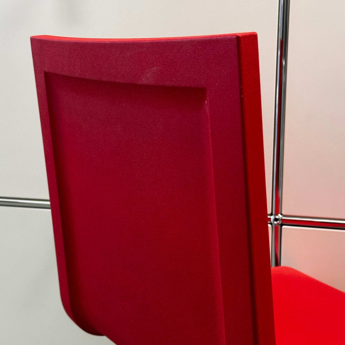 Red Vitra .05 Maarten van Severen chair with stainless steel frame and flexible polyurethane seat shell