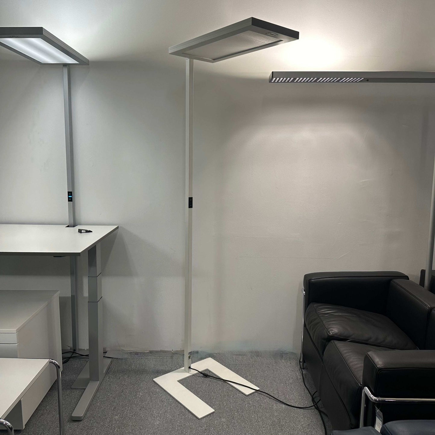 Waldmann Lavigo LED white floor lamp with motion and daylight sensor in modern office setting
