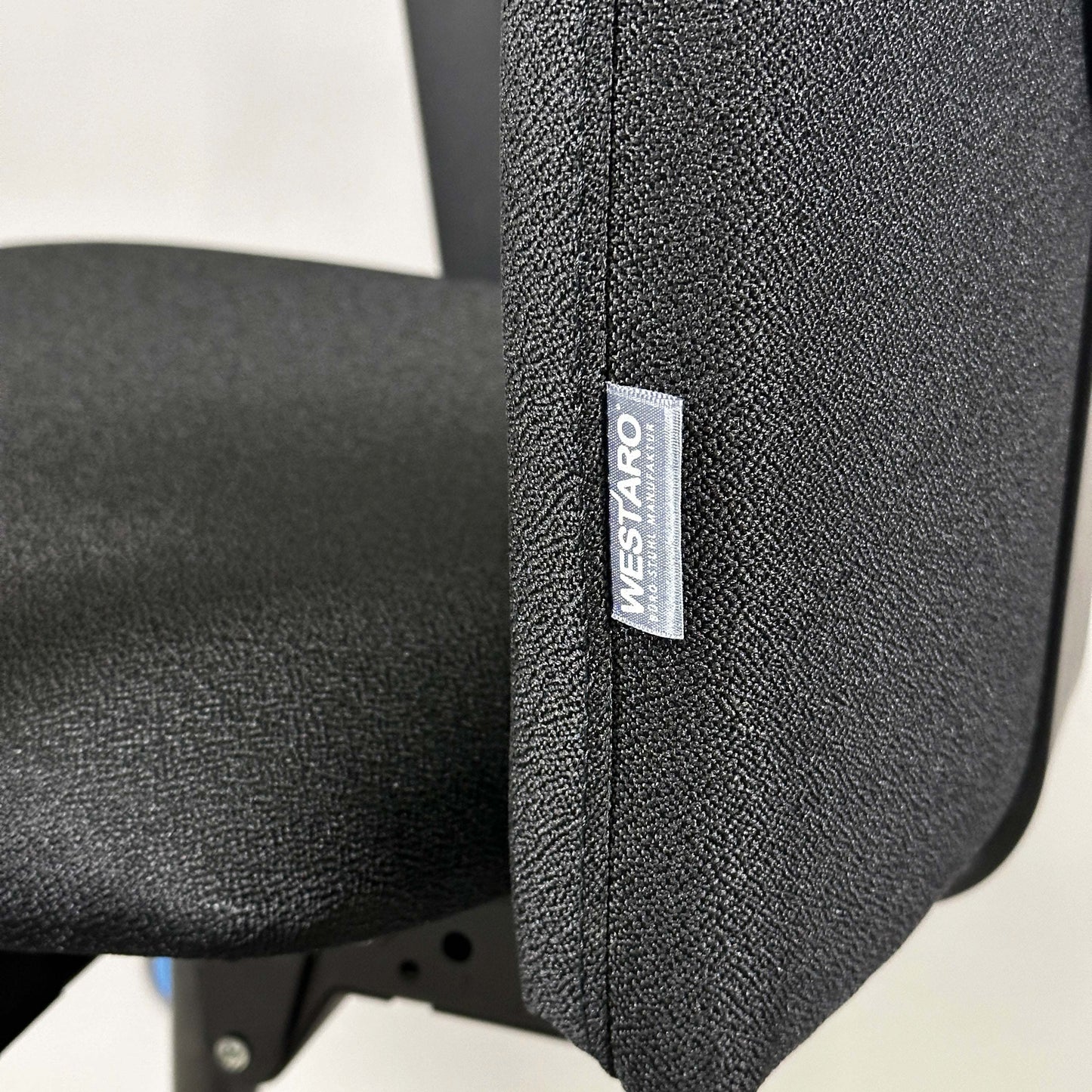 Close-up of black Westaro Enjoy ergonomic office chair fabric and label on backrest