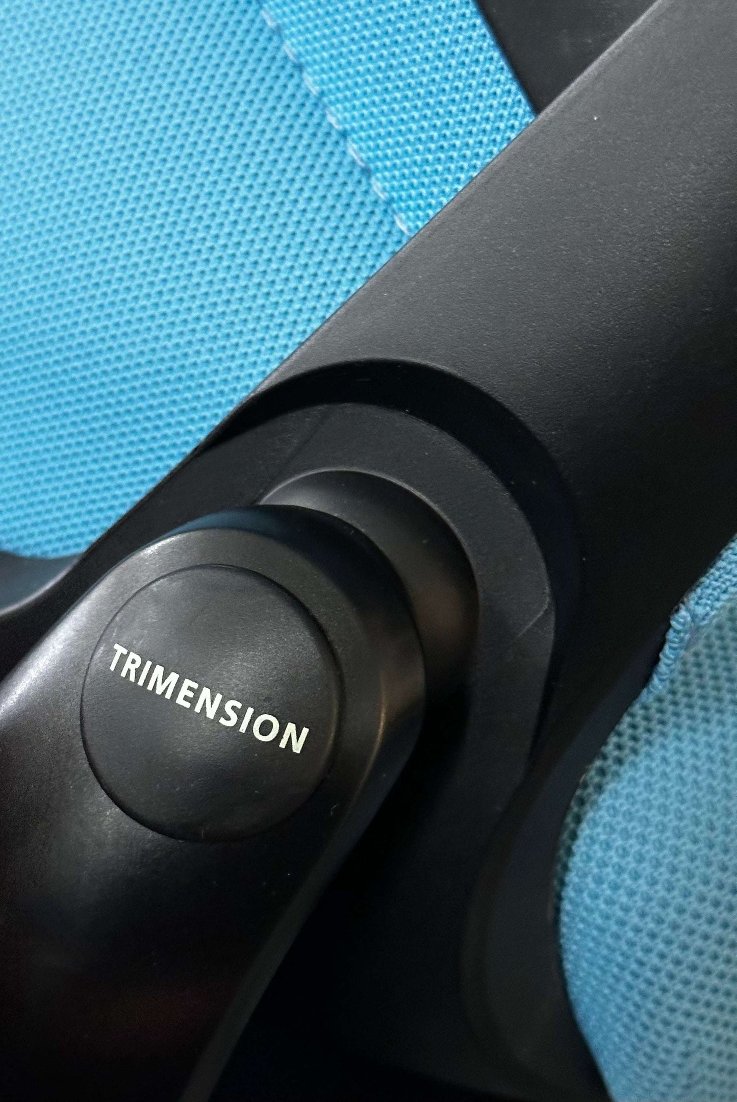 Close-up of the trimension adjustment mechanism on the blue Wilkhahn In 284/1 Counterstuhl ergonomic swivel counter chair