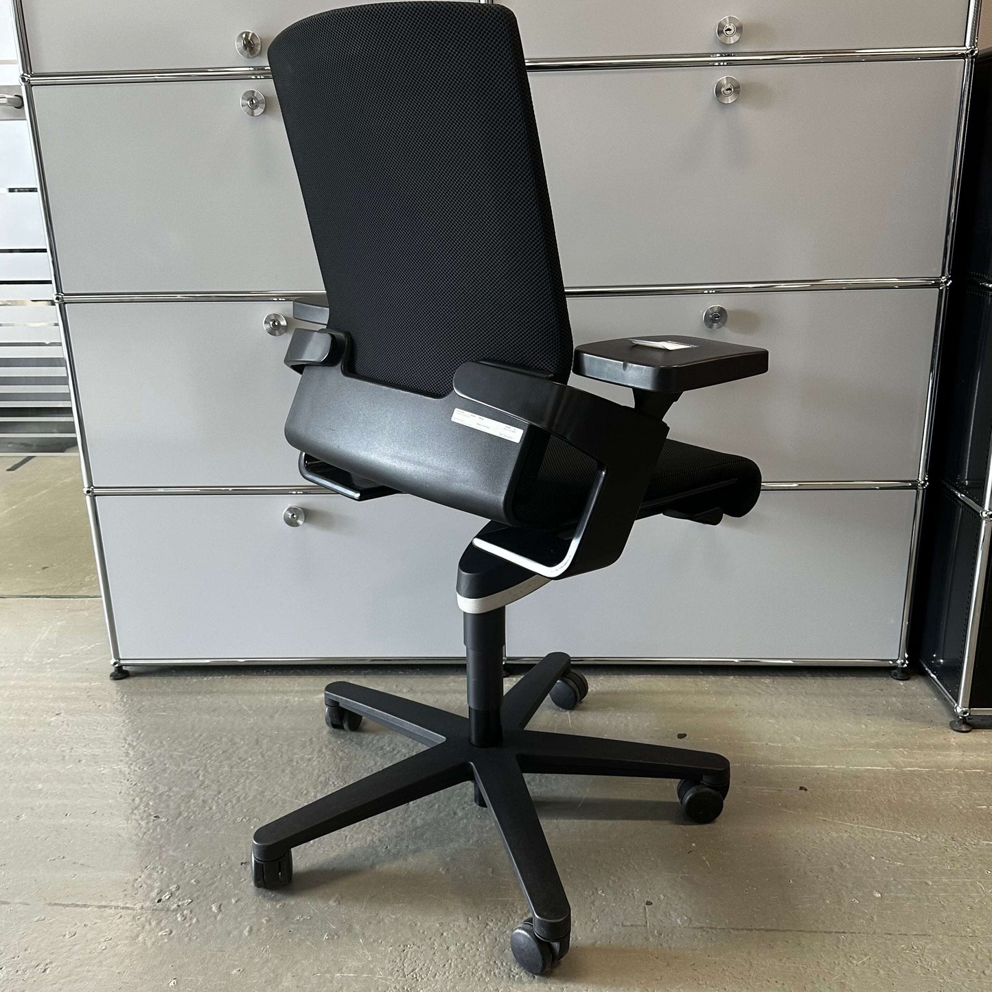 Black Wilkhahn ON ergonomic office chair with adjustable height, depth, and backrest on caster wheels