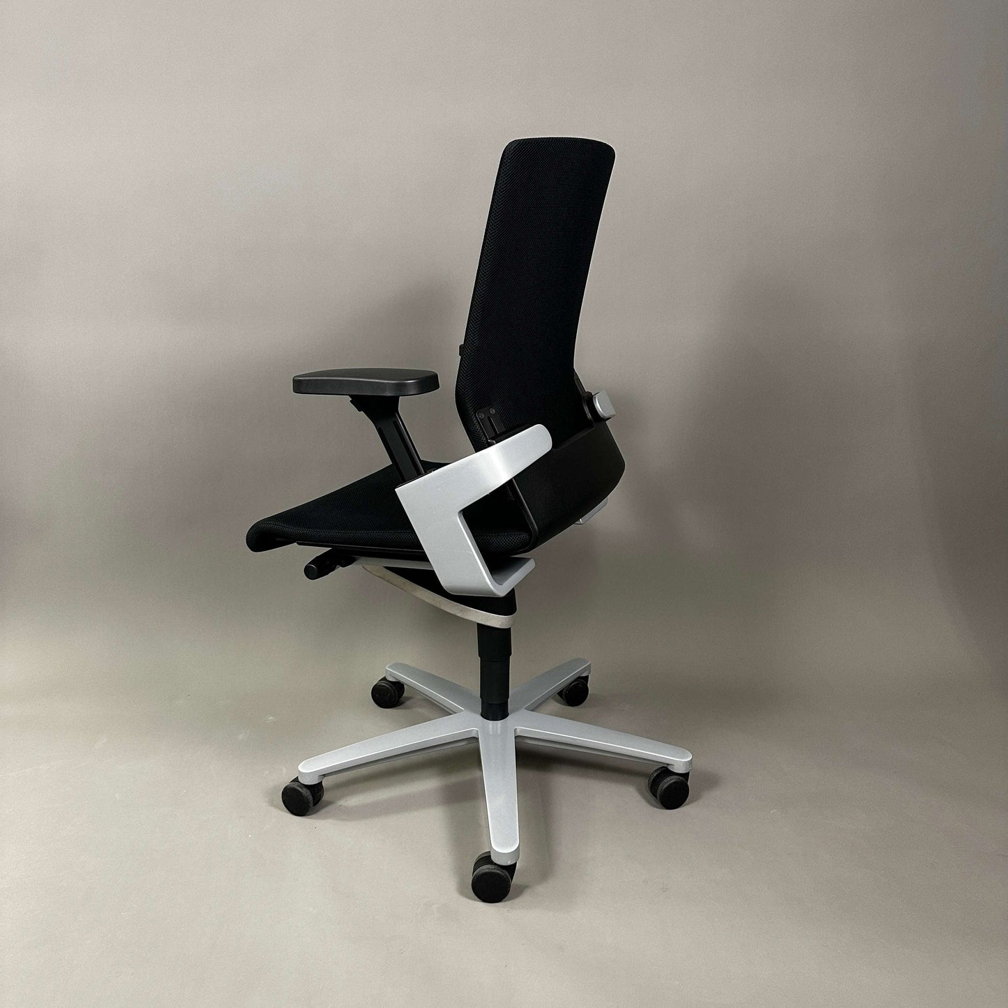 Wilkhahn ON ergonomic office chair with black mesh back, black fabric seat, and silver aluminum base