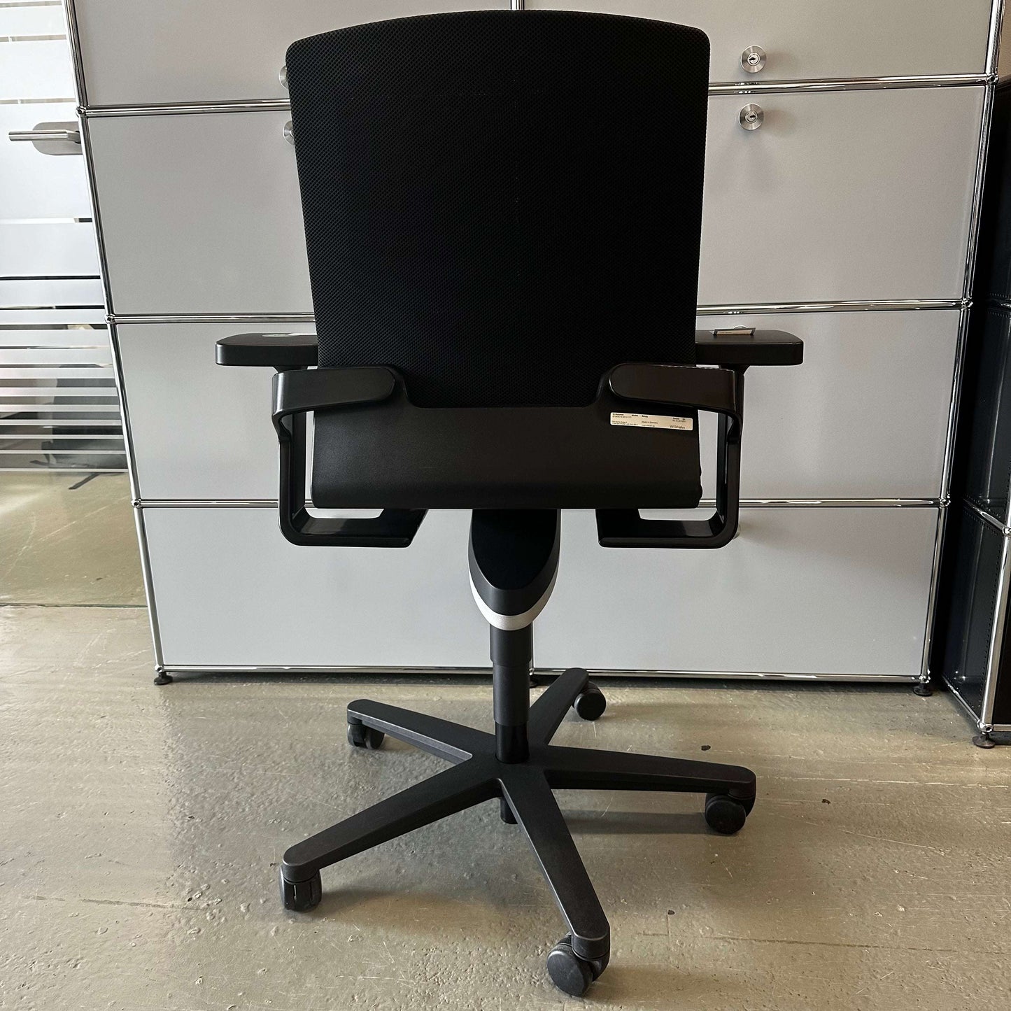 Wilkhahn ON black ergonomic office chair with adjustable height, depth, and lockable backrest on caster wheels