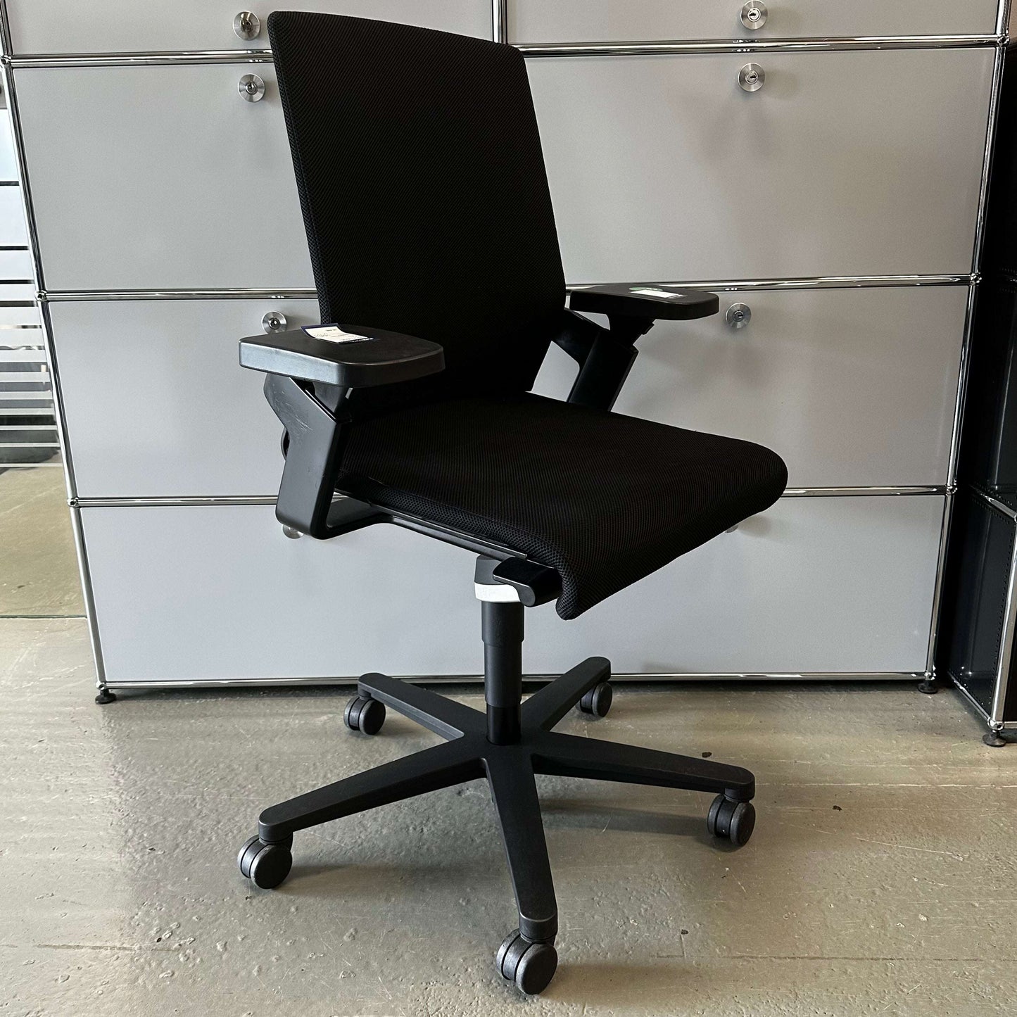 Black Wilkhahn ON office chair with adjustable seat height, depth, and backrest, on caster wheels